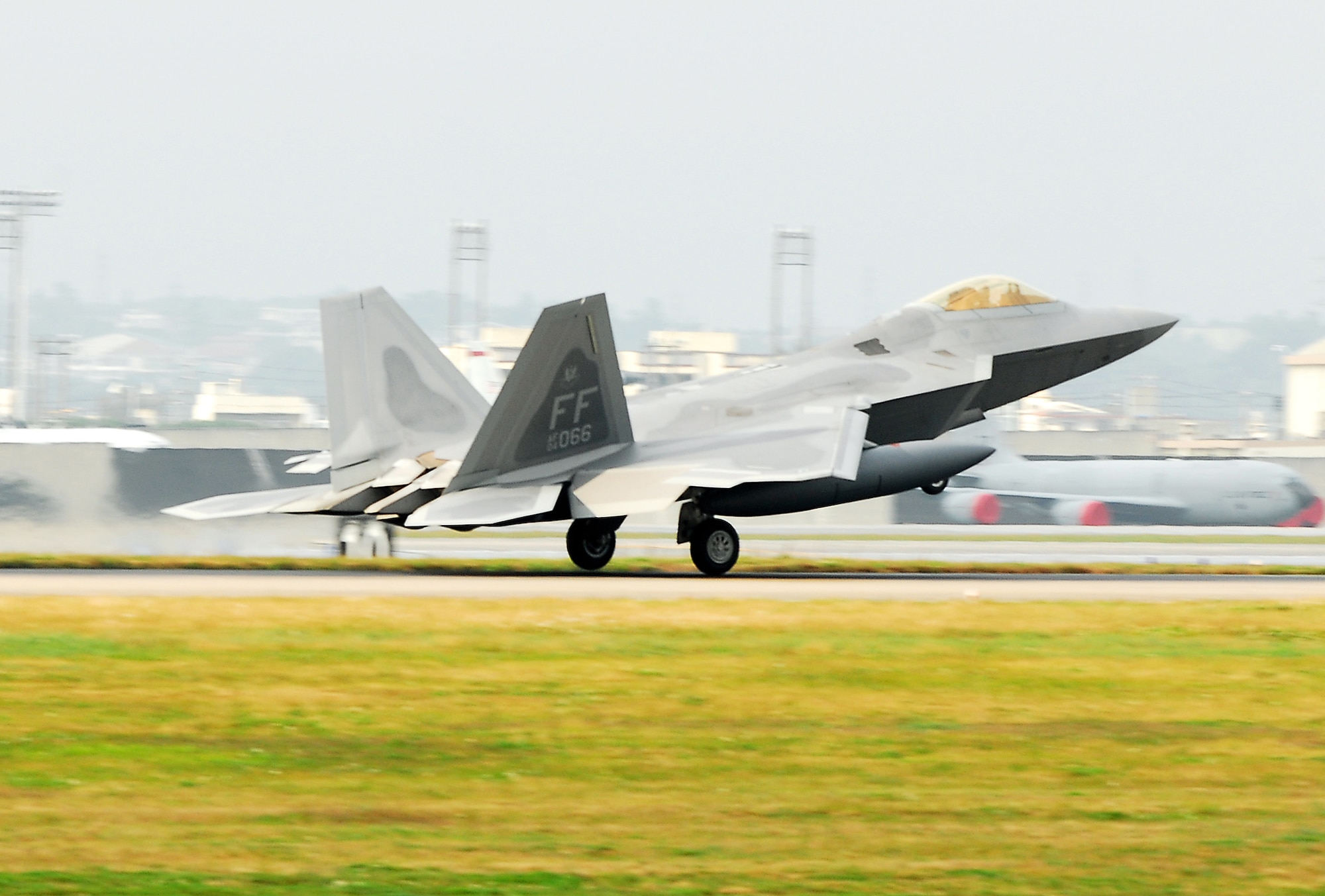An F-22 Raptor lands at Kadena Air Base, Japan, Feb. 18, marking the aircraft's first overseas deployment. The jet is one of 12 along with more than 250 Airmen deployed from Langley Air Force Base, Va., to Kadena as part of an air expeditionary force rotation. (U.S. Air Force photo/Airman 1st Class Kelly Timney)