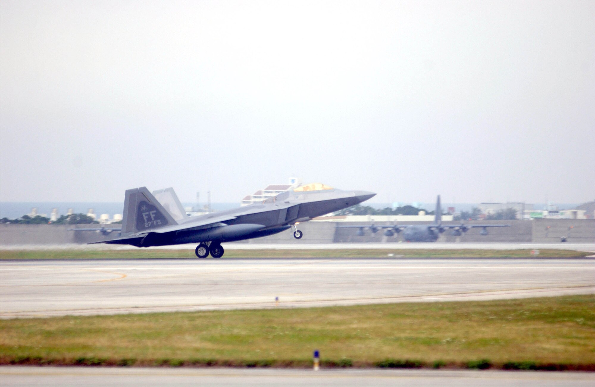An F-22 Raptor lands at Kadena Air Base, Japan, Feb. 18, marking the aircraft's first overseas deployment. The jet is one of 12 along with more than 250 Airmen deployed from Langley Air Force Base, Va., to Kadena as part of an air expeditionary force rotation. (U.S. Air Force photo/Airman 1st Class Ryan Ivacic) 