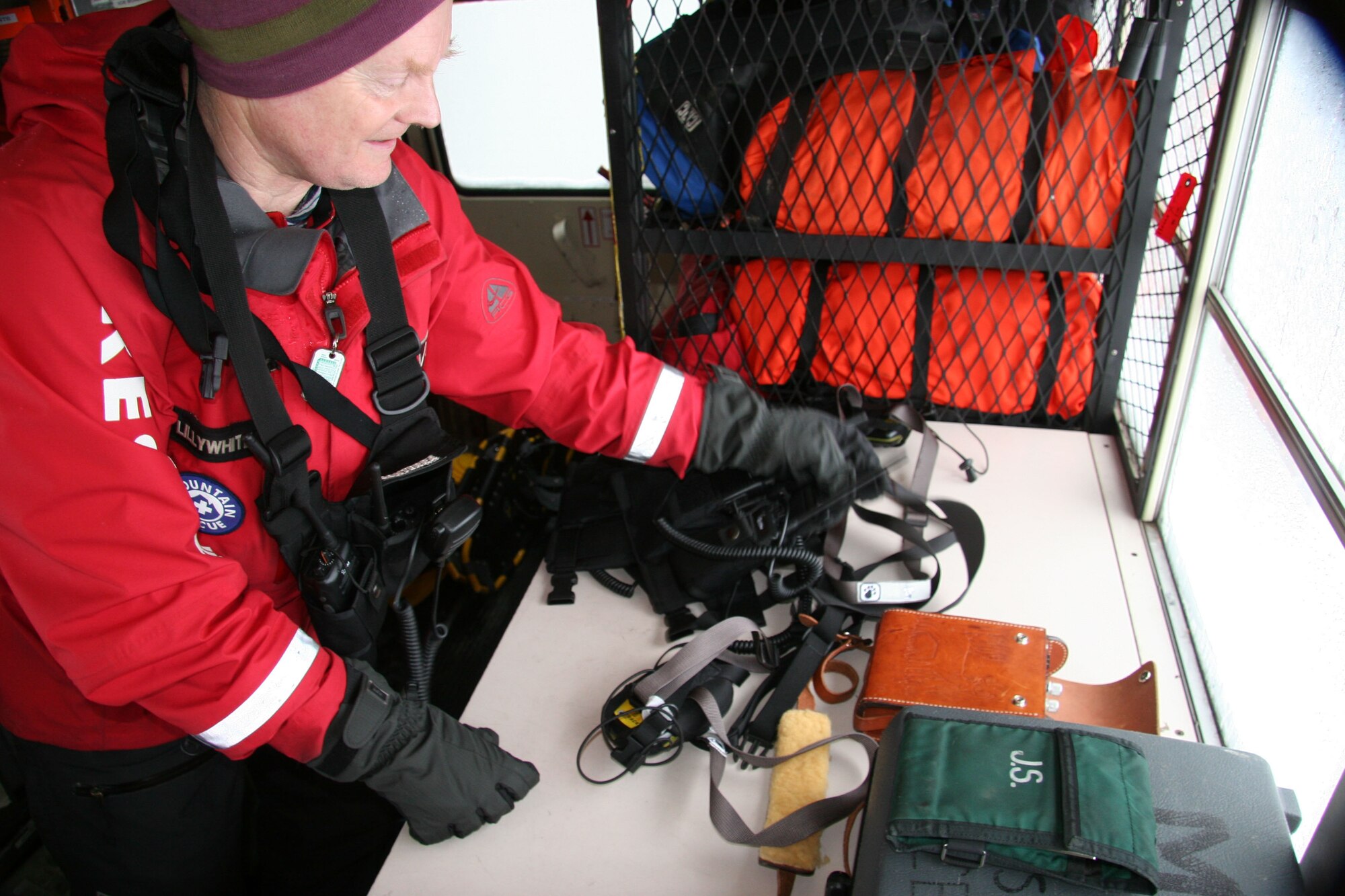 Mr. Hal  Lillywhite, Portland Mountain Rescue command post volunteer, gathers equipment for the rescue teams.  The PMR volunteers gather coordinates from the 304th Rescue Squadron PJs throughout the night to create a pathway for the other rescue teams to search in the morning. (U.S. Air Force Photo/Master Sgt. Ruby Zarzyczny)