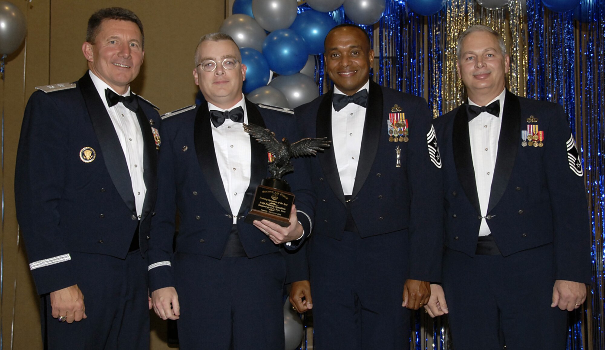 The 372nd Training Squadron is the 2nd Air Force's Squadron of the Year for 2006. Maj. Gen. Mike Gould (left), 2nd AF commander, announced the honor Feb. 16 at the 82nd Training Wing Annual Awards Banquet. The squadron set itself apart by completing over 12,000 hours of community service and earned two Outstanding ratings during September's Operational Readiness Inspection. Also pictured with General Gould, from left to right, Lt. Col. Russell Tutty, 372nd TRS commander, 2nd Air Force Command Chief Chief Master Sgt. Jimmy Kelly Jr., and Chief Master Sgt. Thomas Schroeder, 372nd TRS superintendent. (U.S. Air Force photo/Sandy Wassenmiller)