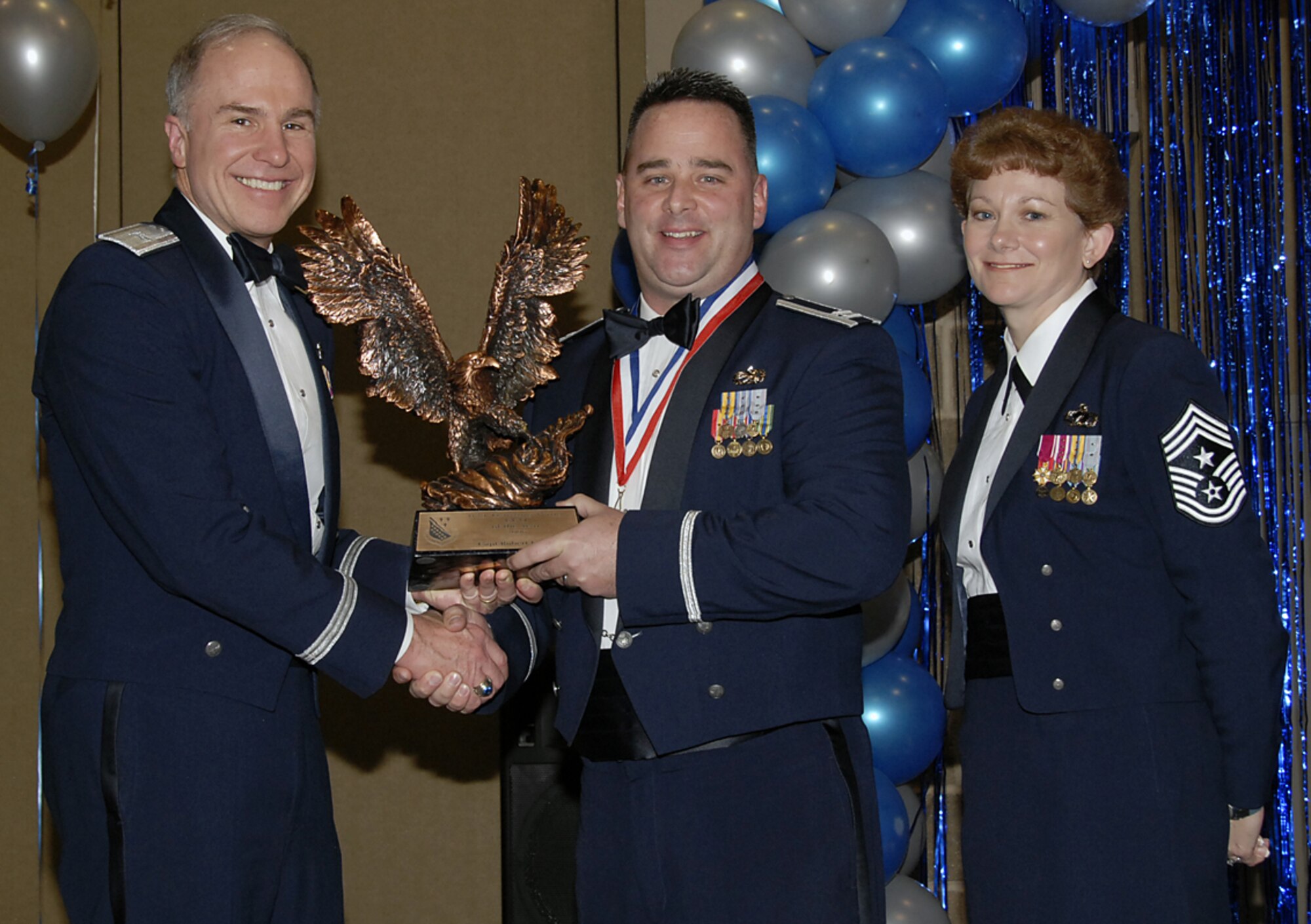 Capt. Robert Lewin of the 372nd Training Squadron is the 2006 Company Grade Officer of the Year for the 82nd Training Wing. He was a key player in the 372nd TRS's Outstanding rating during the Operational Readiness Inspection in 2006 and the squadron's honor of being the 82nd TRW Squadron of the Year. Brig. Gen. Richard Devereaux (left), 82nd TRW commander, and Chief Master Sgt. Jeannie McLean, 82nd TRW command chief, present the award Feb. 16 at the annual awards banquet. (U.S. Air Force photo/Sandy Wassenmiller)