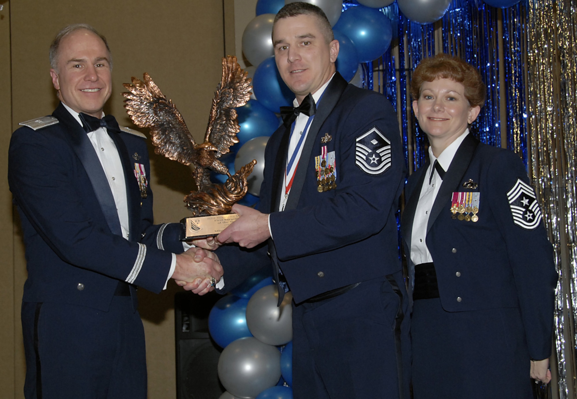 Brig. Gen. Richard Devereax (left), 82nd Training Wing commander, and wing Command Chief Chief Master Sgt. Jeannie McLean present the 2006 First Sergeant of the Year award to Master Sgt. Rod Ebner Feb. 16 at the annual awards banquet. Sergeant Ebner was recognized for his efforts during a deployment to Iraq where he served as first sergeant for more than 900 Airmen. He worked closely with the Army to assist in the transition of over 7,000 Soldiers. (U.S. Air Force photo/Sandy Wassenmiller)