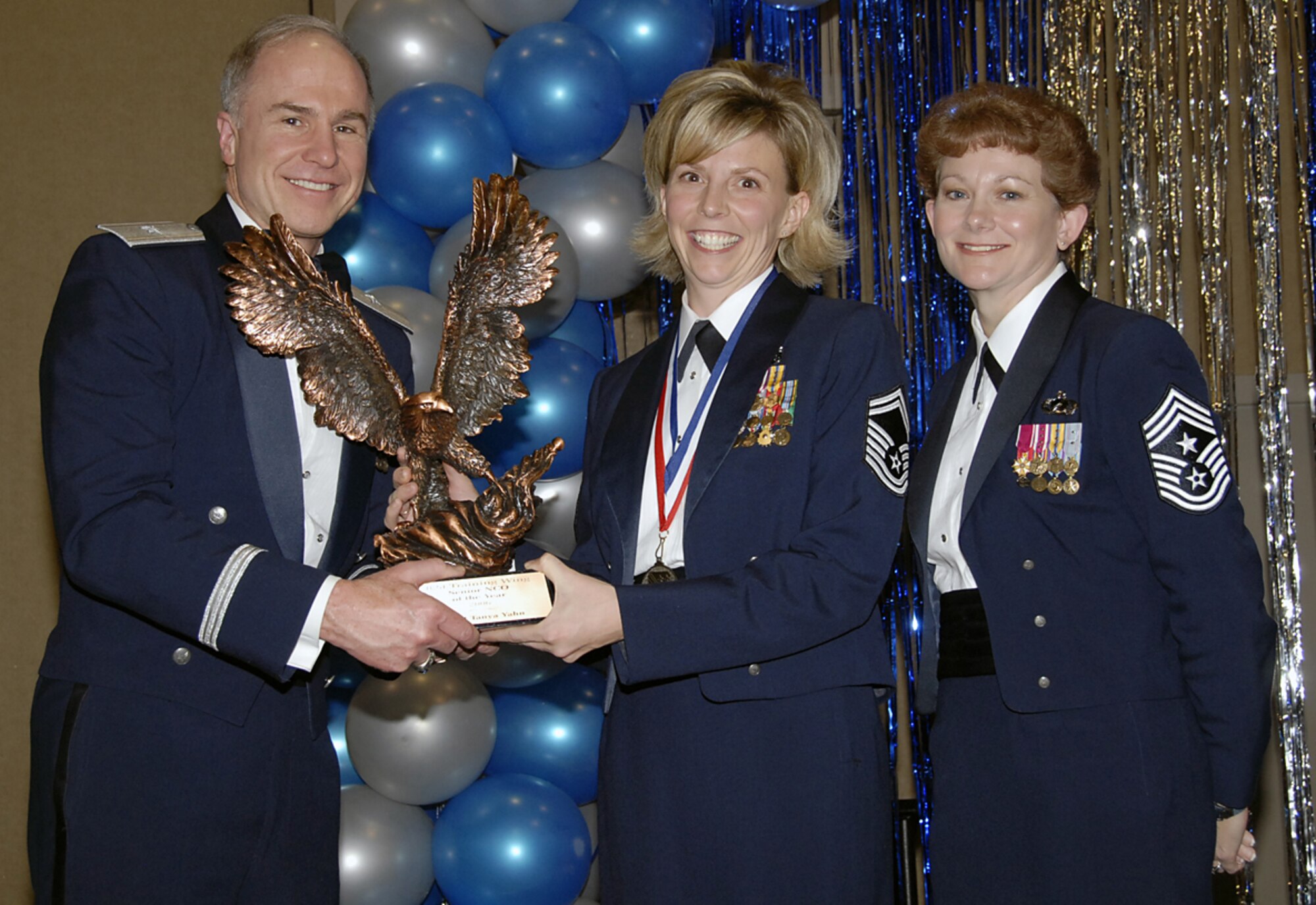 Senior Master Sgt. Tanya Yahn of the 82nd Medical Support Squadron is the 2006 Senior Noncommissioned Officer of the Year for the 82nd Training Wing. Sergeant Yahn was recognized as one of the top resource advisors in Air Education and Training Command and managed more than $75,000 in temporary duty funds and $8.5 million in supply budgets for nine cost center managers. Brig. Gen. Richard Devereaux, 82nd TRW commander, and wing Command Chief Chief Master Sgt. Jeannie McLean presented Sergeant Yahn's award to her Feb. 16 at the annual wing awards banquet. (U.S. Air Force photo/Sandy Wassenmiller)