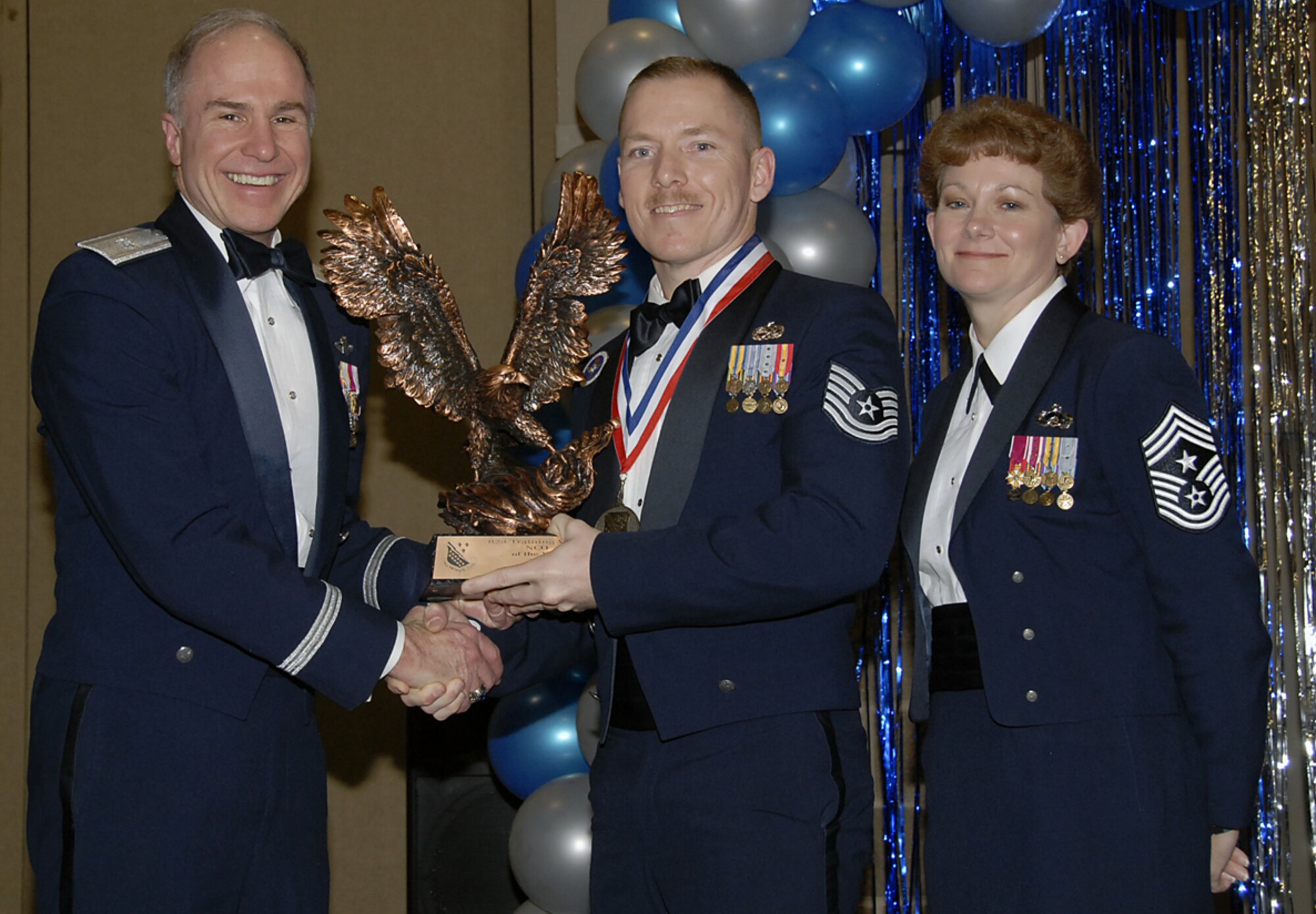 Tech. Sgt. Leonard Acosta of the 360th Training Squadron is presented a trophy Feb. 16, honoring him as the 2006 Noncommissioned Officer of the Year. Sergeant Acosta was recognized for his performance during a maintenance inspection in 2006. He was also responsible for 1,200 Airmen, 23 instructors and five aircraft trainers worth $15 million. Also pictured with Sergeant Acosta is Brig. Gen. Richard Devereaux, 82nd Training Wing commander, and 82nd TRW Command Chief Chief Master Sgt. Jeannie McLean. (U.S. Air Force photo/Sandy Wassenmiller)