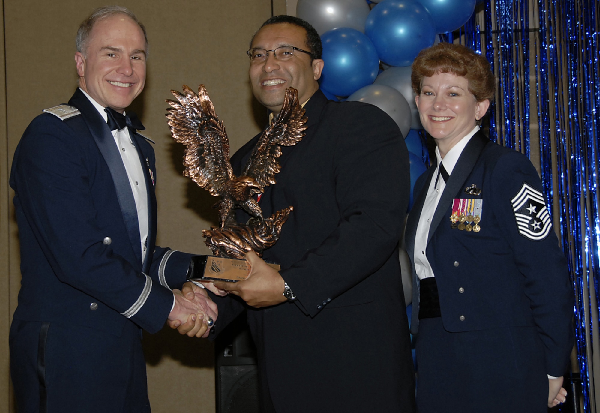 Tony McCurdy of the 82nd Medical Support Squadron is the 2006 Senior-level Civilian of the Year. Mr. McCurdy's quarterly awards as resouce advisor and 82nd Medical Group civilian of the quarter, as well as the Air Education and Training Command Medical Resource Manager of the Year led to his honor at the wing level. Also pictured with Mr. McCurdy are 82nd Training Wing Commander Brig. Gen. Richard Devereaux and Chief Master Sgt. Jeannie McLean, the 82nd TRW command chief. Wing-level awards were presented at a banquet Feb. 16. (U.S. Air Force photo/Sandy Wassenmiller)