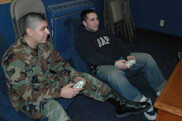 EIELSON AIR FORCE BASE, Alaska--Senior Airmen Dominic Garcia and Robert Rosa, both of the 354th Communications Squadron, play a game of Halo 2 after work March 16 at the North Star Cafe in building 2333. Airman Garcia is the Eielson point of contact for Newtroop, an online gaming circuit for servicemembers who play online Xbox, PlayStation and computer games. (U.S. Air Force photo by Airman 1st Class Nora Anton)