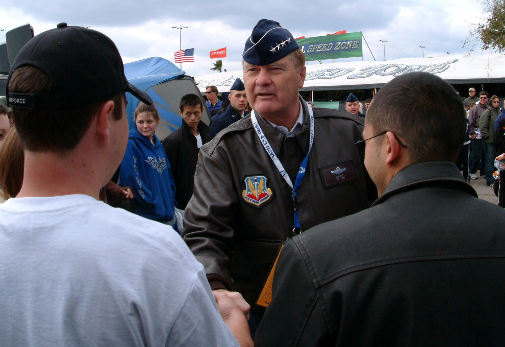 Gen. Ronald Keys, Air Combat Command commander, shakes hands with the newly sworn-in Airmen Feb. 18 before the Daytona 500 race. General Keys gave the oath of enlistment to 36 delayed-entry-program recruits from the local area.  Afterward, the new Airmen and the general were treated to a tour of the garage and pit areas before the race.  The Air Force is one of the sponsors of the No. 21 Wood Brothers car driven by Ken Schrader.  (U.S. Air Force photo/Staff Sgt. Samuel King Jr.)