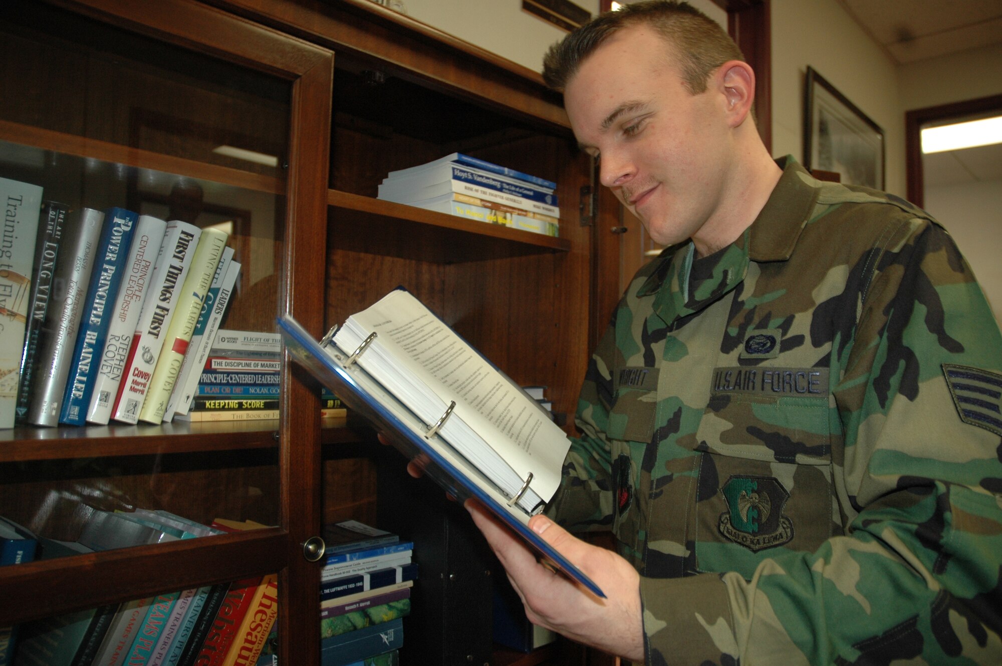 MINOT AIR FORCE BASE, N.D. -- Staff Sgt. Aaron Wright, 5th Bomb Wing Manpower and Organization office, reads an Air Force instruction manual Feb. 20. The manpower office recently won the 2006 Air Combat Command Best Small Manpower and Organization Award for Professional Excellence. (U.S. Air Force photo by Senior Airman Danny Monahan)