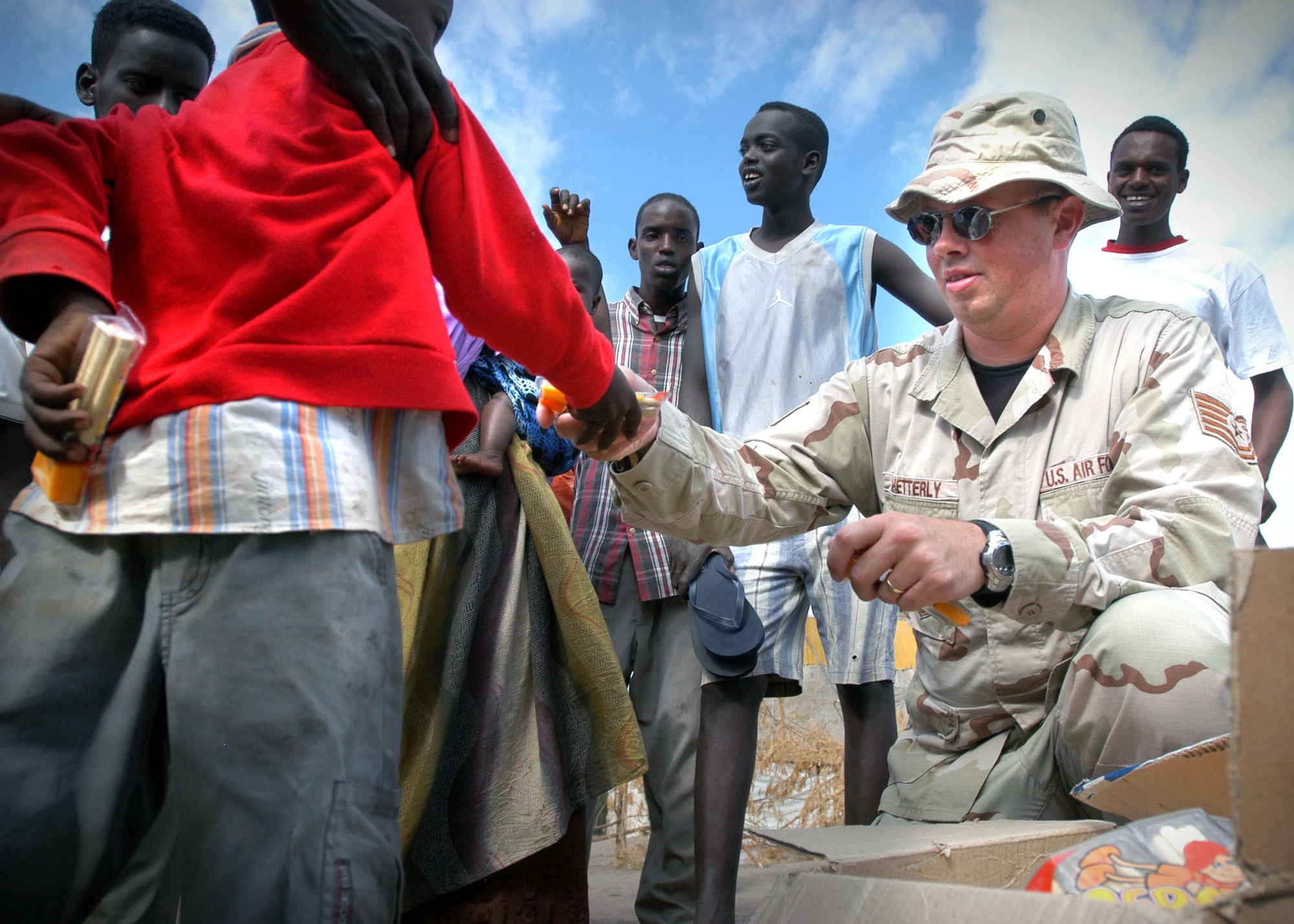 Tech. Sgt. Chris Shetterly gives away candy to children Jan. 9 during a visit to Damerjong district, Djibouti.  The candy was donated by the 350th Civil Affairs Company, attached to the Combined Joint Task Force - Horn of Africa.  (U.S. Navy photo/Chief Petty Officer Eric A. Clement)