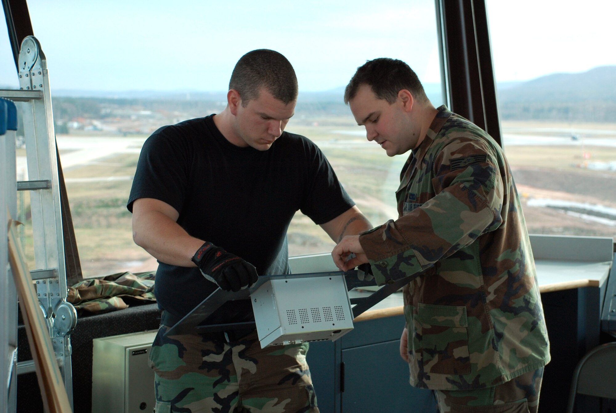 Staff Sgts. Michael Sweet and David Coleman prepare to install a panel Feb. 14 during the renovation of the air traffic control tower at Ramstein Air Base, Germany.  The tower is undergoing approximately $300,000 worth of upgrades.  Work is progressing on time and within budget.  The tower staff expects to be fully operational in the "new" tower by March 1.  (U.S. Air Force photo/Staff Sgt. Dan Bellis) 