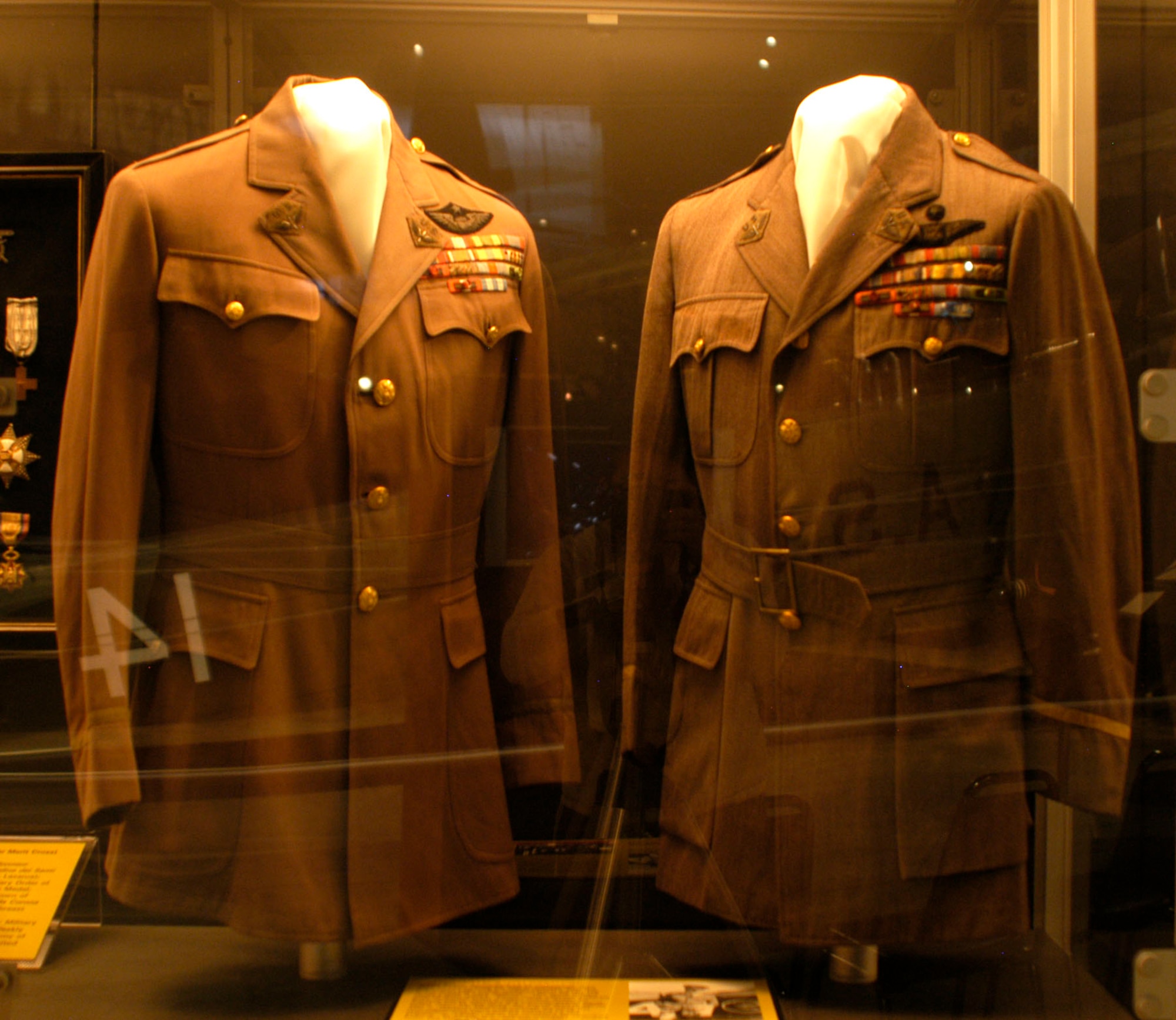 DAYTON, Ohio - Gen. Billy Mitchell's jackets on display in the Early Years Gallery at the National Museum of the U.S. Air Force. The jacket on the right is a non-regulation lapel collar jacket tailored for Gen. Billy Mitchell in July 1923. The jacket on the left is the non-regulation lapel collar jacket tailored for Mitchell in November 1924. This jacket is possibly the one worn by Mitchell during his court martial in December 1925. (U.S. Air Force photo)