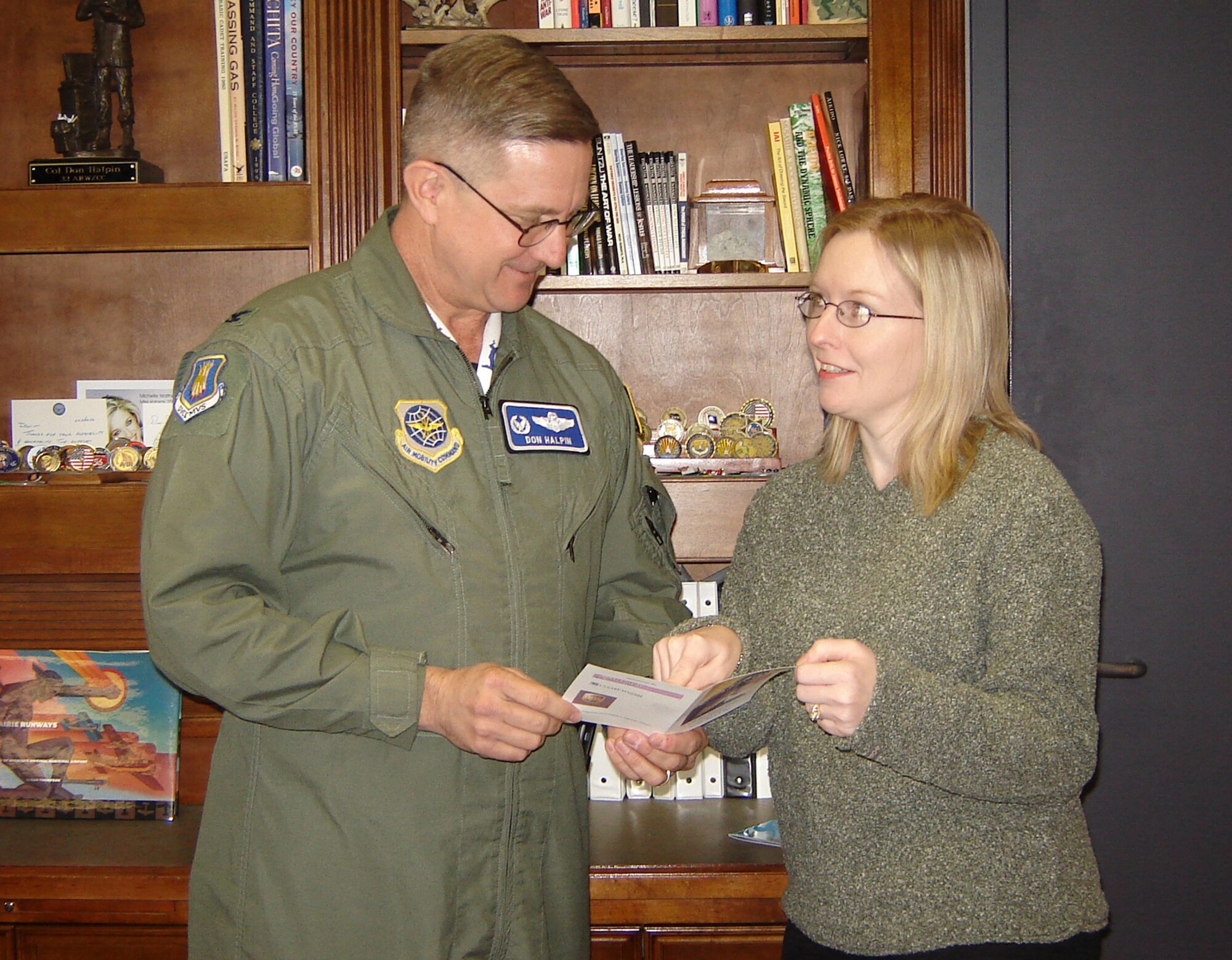 Feb. 16, Amy Myer, right, McConnell Officers’ Spouses’ Charitable Association president, hands Col. Donald J. Halpin, 22nd Air Refueling Wing commander, an invitation the upcoming MOSCA Charity Auction. The Fifth Annual MOSCA Charity Auction will be held March 3 at the Terradyne Country Club, Andover. The theme for the event is “United We Stand.” The silent auction will begin at 6 p.m. and the live auction will begin at 7:30 p.m. Dress is semi-formal. There will be hors d’oeuvres and a cash bar. Cost is $35 per person in advance or $40 at the door/$50per couple or $60 at the door. Proceeds from the auction benefit base organizations such as the MOSCA Scholarship program, Airman and Family Readiness programs and more.