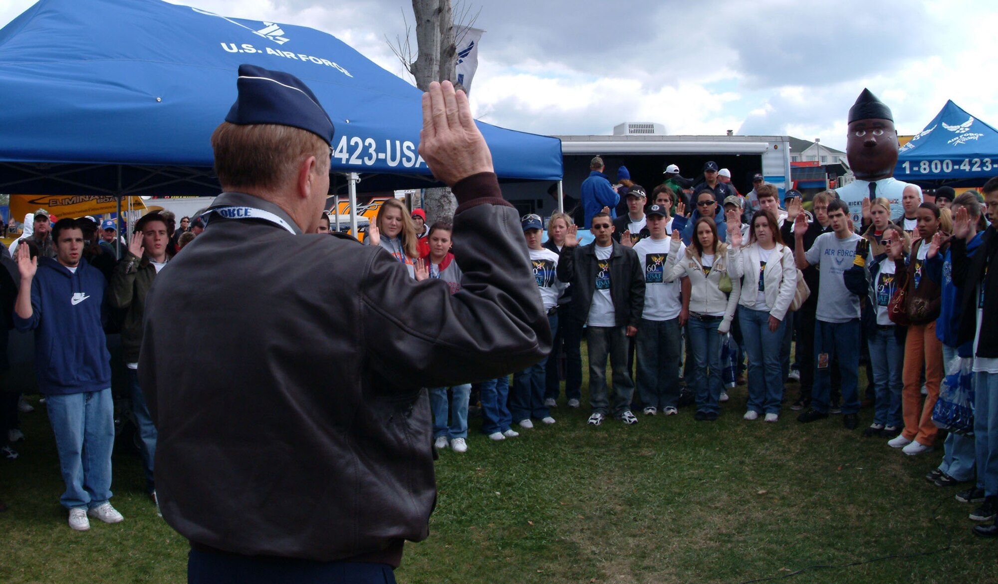 Gen. Ronald Keys, Air Combat Command commander, gives the oath of enlistment to 36 new Airmen Sunday before the Daytona 500.  Afterward the new Airmen and the general were treated to a garage and pit tour before the race. The general also met with car owners, the Wood Brothers and driver Ken Schrader. The Wood Brothers run the Air Force paint scheme on their car for numerous races throughout the year.(Photo by Staff Sgt. Samuel King, Jr.)