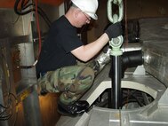 MINOT AIR FORCE BASE, N.D. -- Staff Sgt. Michael Stanke, 5th Communications Squadron, runs fiber-optic cable into the launch control center at missile alert facility Golf-01 Feb. 15. The cable is connected to a computer monitor located inside the LCC for the use of Netlink. Providing high-speed Internet access, Netlink allows missile crews to work on professional military education, graduate degree programs and correspondence such as staff packages, performance reports, awards and decorations. (U.S. Air Force photo by Airman 1st Class Cassandra Butler)