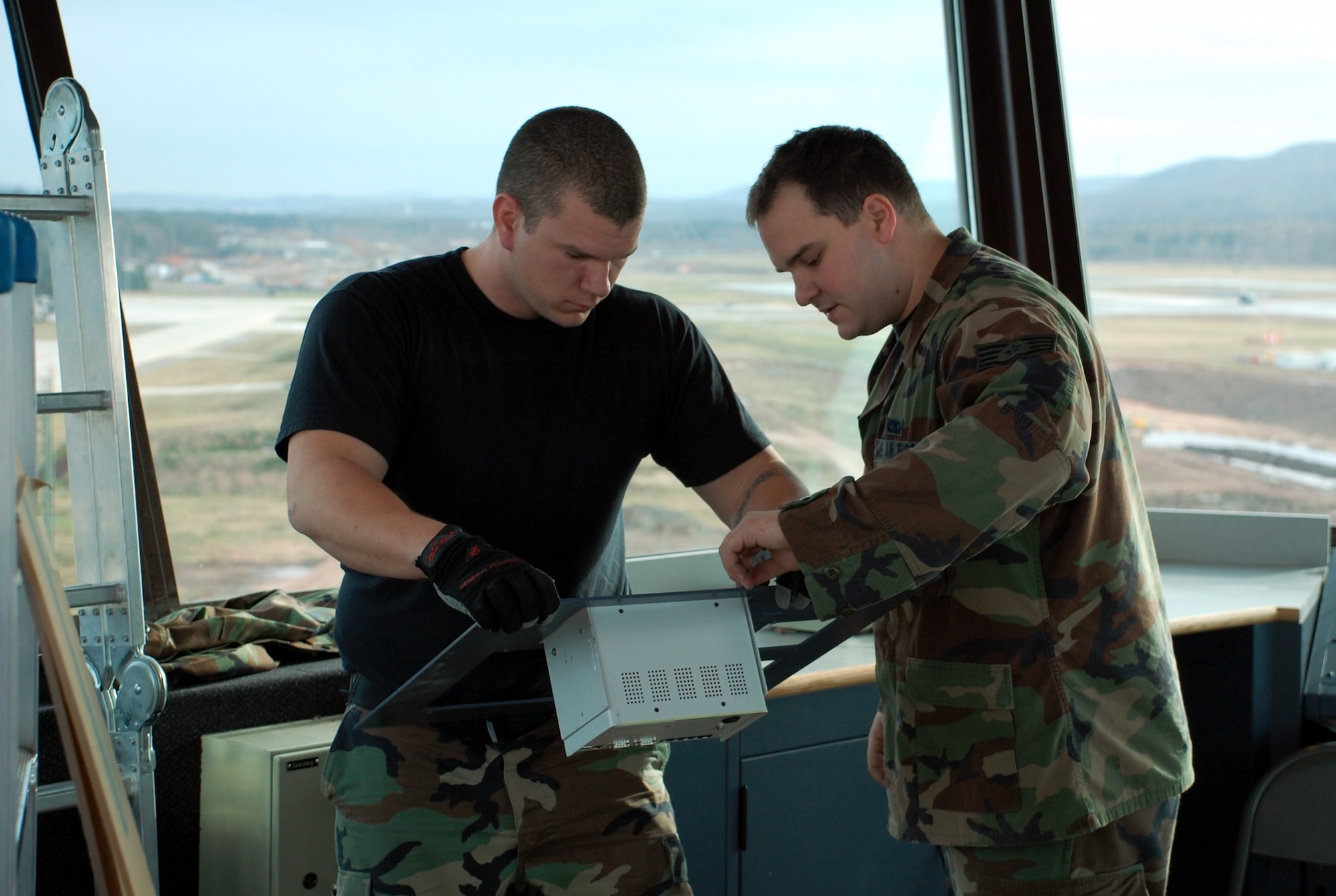 Staff Sgts. Michael Sweet and David Coleman examine a component in Ramstein Air Base’s air traffic control tower.  The tower is currently undergoing approximately $300,000 of renovations. (Air Force Photo by Staff Sgt. Dan Bellis) 