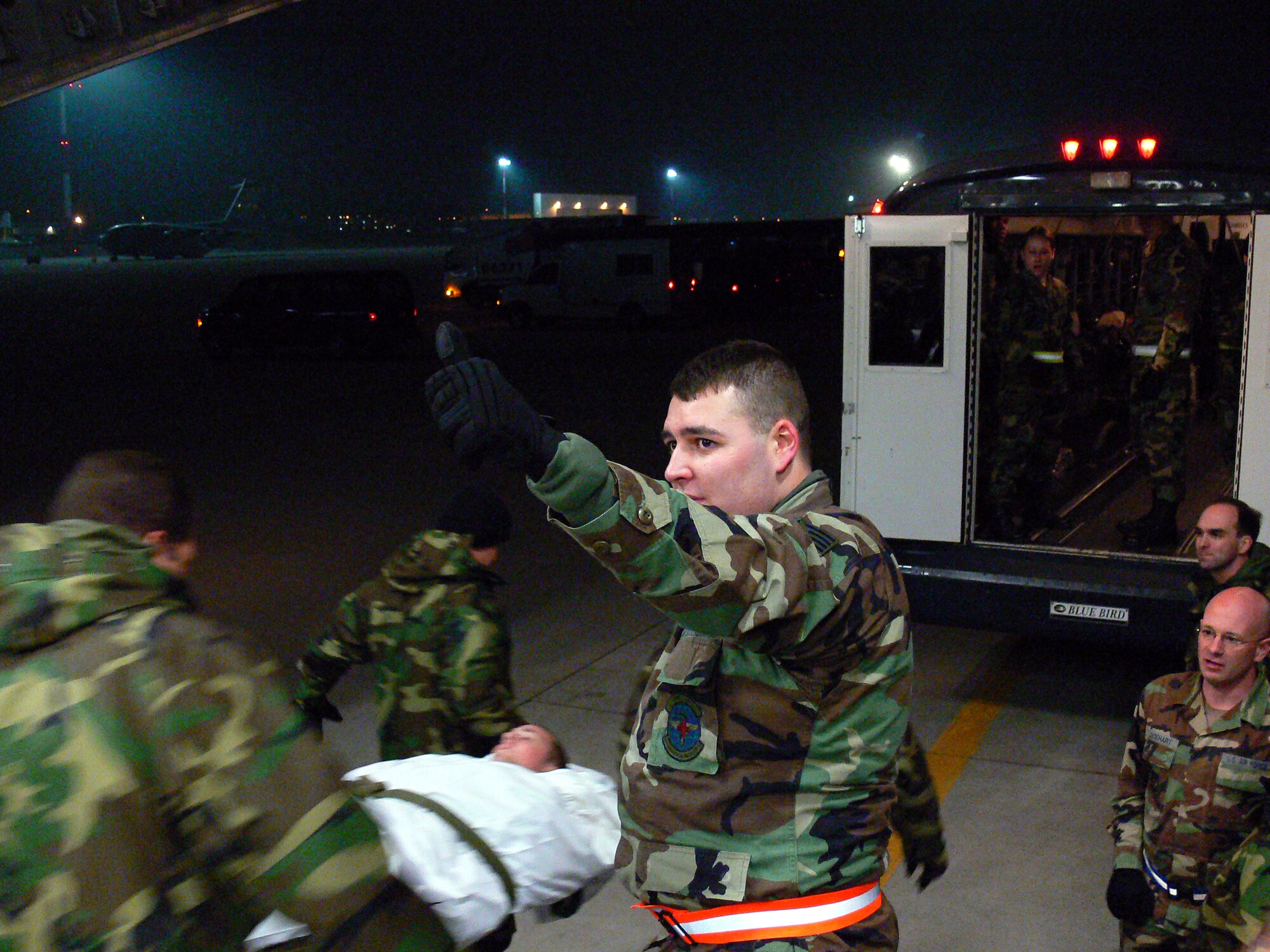 Staff Sgt. Ricky Tackett overseas the loading of a wounded Marine onto a bus destined to Landstuhl Regional Medical Center.  The 11 wounded troops arrived onboard a C-17 following a helicopter crash in Southeast Afghanistan only hours earlier.  Staff Sgt. Talbert is medical technician in the 435th Aeromedical Staging Flight from Ramstein Air Base, Germany.
