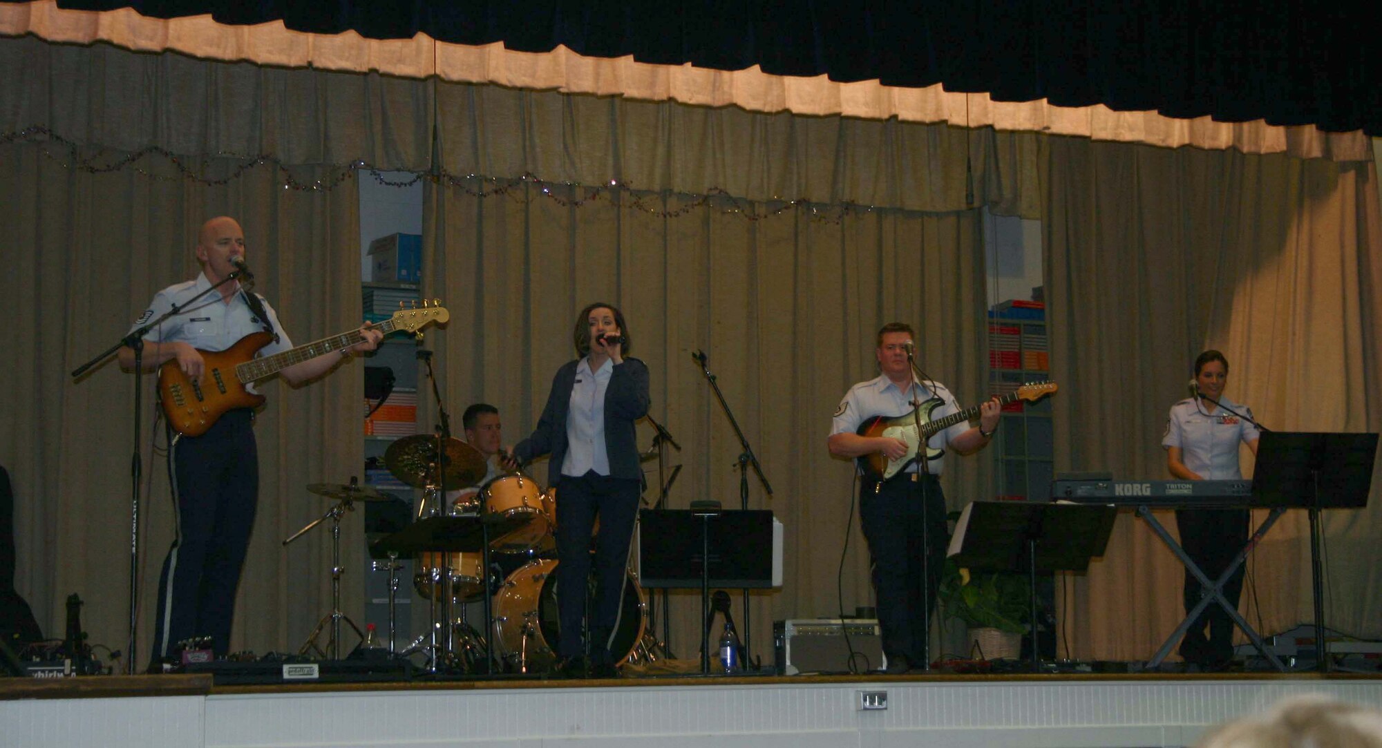 Top Flight bandmembers bass guitarist Tech. Sgt. Jon Packard, drummer Airman 1st Class Andy Wendzikowski, lead singer Tech. Sgt. Donna Siler, guitarist Tech. Sgt. Steve Wilson and keyboardist Master Sgt. Sarah DeLuzio.  The band entertained the students at Sheppard Elementary Feb. 12. (U.S. Air Force Photo/Staff Sgt. Tonnette Thompson)