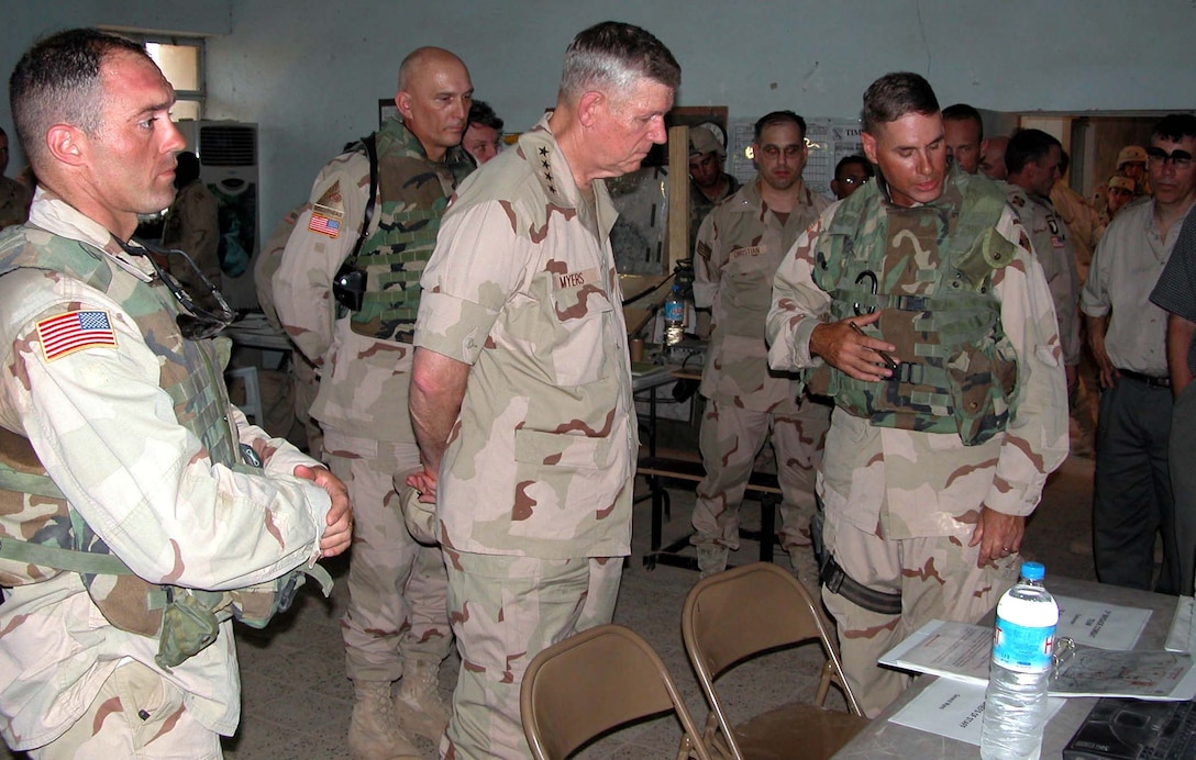 Air Force Gen. Richard B. Myers, center, listens to a briefing  from Army Col. Frederick Rudesheim, right, and Army Lt. Col. Nate Sassaman at  the headquarters of the 1st Battalion, 8th Infantry, at Balad, Iraq. Behind  Myers is 4th Infantry Division commander Maj. Gen. Ray Odierno. Photo by Jim  Garamone