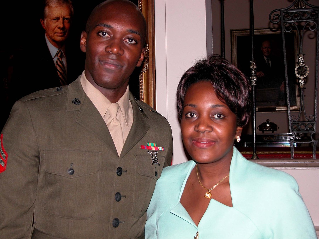 Marine Cpl. Guyp Tchoumba, of the Marine  Corps Security Forces Battalion, Norfolk, Va., is met by  his sister Emma Gjiya after the July 1 White House ceremony  marking the 30th anniversary of the all-volunteer force. The  Republic of Cameroon, West Africa, native traveled from New  York City to witness her brother re-enlist for four more  years of service. Photo by Sgt. 1st Class Doug Sample.
