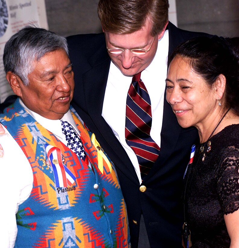 Army Spc. Lori Piestewa's parents, Terry  Piestewa, left, and Priscilla "Percy" Piestewa, are  consoled by Daniel McIntyre, chief executive officer,  Triwest Health Care, after the unveiling of the exhibit  honoring Native American women May 26 at the Women's  Memorial in Arlington, Va. Lori was killed during Operation  Iraqi Freedom. Photo by Rudi Williams