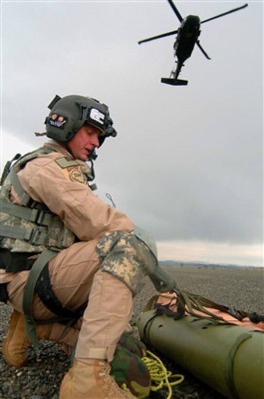 U.S. Army Sgt. Robert Cowdrey prepares a mock casualty in a rescue sled to be hoisted hundreds of feet into an UH-60 Black Hawk helicopter during a training exercise at Forward Operating Base Salerno, Afghanistan, on Feb. 15, 2007.  Cowdrey is a flight medic from Charlie Company, 3rd Battalion, 82nd Aviation Brigade, 82nd Airborne Division.  