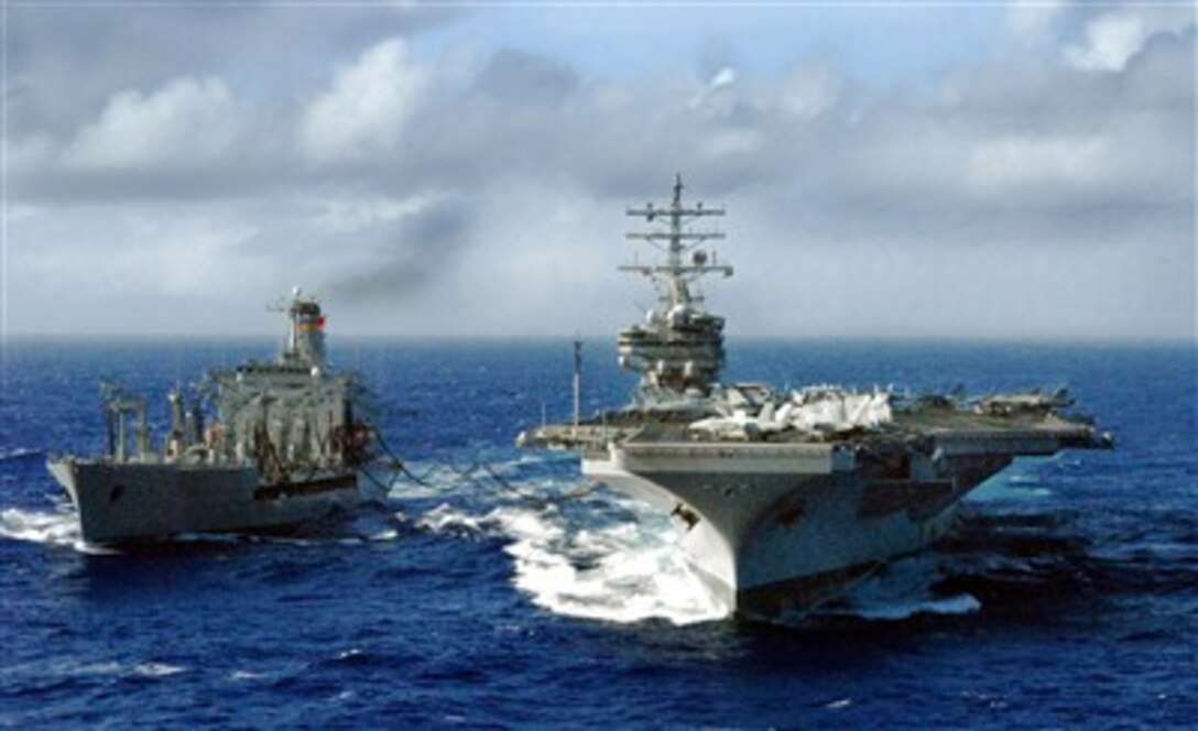 Military Sealift Command fleet replenishment oiler USNS Pecos transits alongside the Nimitz-Class aircraft carrier USS Ronald Reagan during a scheduled refueling-at-sea Feb. 15, 2007. The Ronald Reagan Carrier Strike Group is currently underway on deployment in support of U.S. military operations in the Western Pacific. 