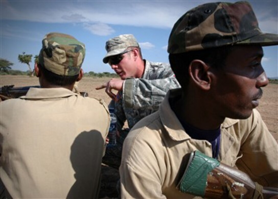 U.S. Army Sgt. Casey Belousky (center) discusses the proper way to conduct a perimeter watch with Ethiopian National Defense Force service members as part of Combined Joint Task Force - Horn of Africa's train the trainer course in Hurso, Ethiopia, on Dec. 27, 2006.  The course teaches students how to train others in their nation's military to increase their nation's capability to protect its borders and ports.  Belousky is with Alpha Company, 1st Battalion, 16th Infantry Regiment.  