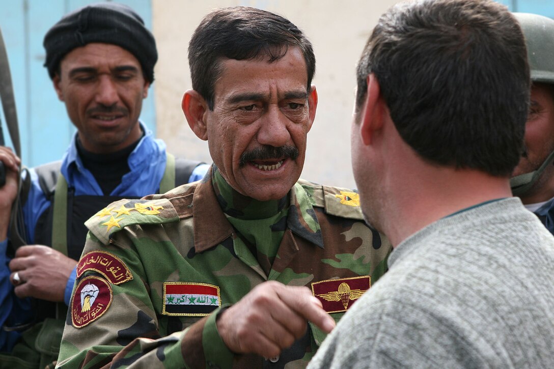 HIT, Iraq ? In this photo taken earlier this year, Brig. Gen. Hamid Ibrahim Jazaa, the former Hit-district police chief, speaks to one of the local citizens during his walk through the market.  This show of faith in the city?s security came days after Operation Police Victory, which was both conceived and executed by the Iraqi Police themselves.