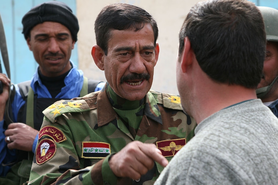 HIT, Iraq ? In this photo taken earlier this year, Brig. Gen. Hamid Ibrahim Jazaa, the former Hit-district police chief, speaks to one of the local citizens during his walk through the market.  This show of faith in the city?s security came days after Operation Police Victory, which was both conceived and executed by the Iraqi Police themselves.