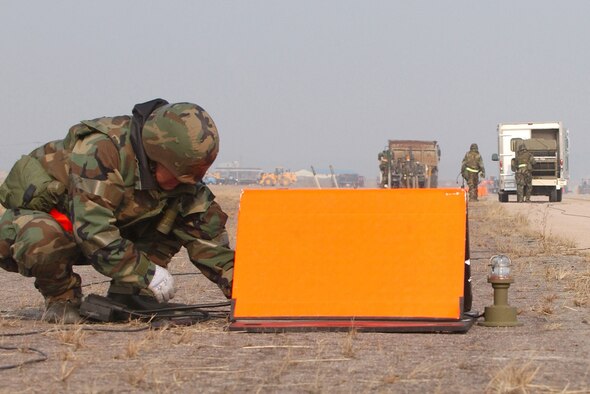 Members of the 8th Civil Engineering Squadron Airfield Damage Repair (ADR) team, install temporary runway lighting during an Operational Readiness Exercise, Wednesday, February 21, 2007 at Kunsan AB, Republic of Korea.  ADR teams do everything from crater repair to airfield lighting making it possible to get aircraft back in the air quickly. (U.S. Air Force Photo/Master Sgt Jack Braden)