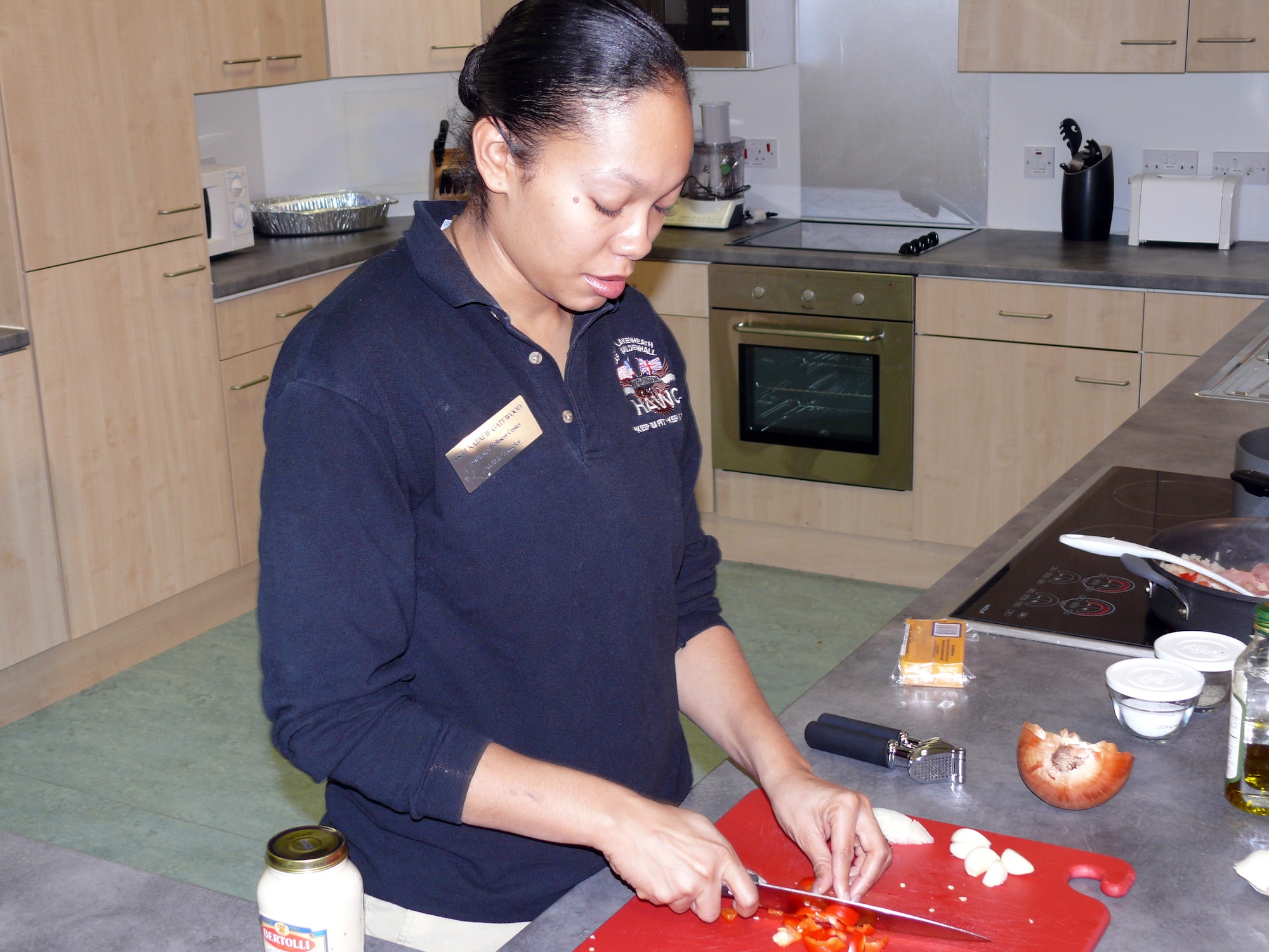 Staff Sgt. Natalie Gatewood chops a red pepper to add to the recipe she's preparing for a Body Composition Improvement Program healthy cooking class Feb. 16 at Royal Air Force Lakenheath, England. Airmen may choose to attend the cooking class as their monthly BCIP follow-up, instead of a typical nutrition briefing. Sergeant Gatewood developed the class due to the need of helping develop better cooking habits for the people on the program. She is the RAF Lakenheath nutrition counselor. (U.S. Air Force photo/Tech. Sgt Scott Wakefield)
