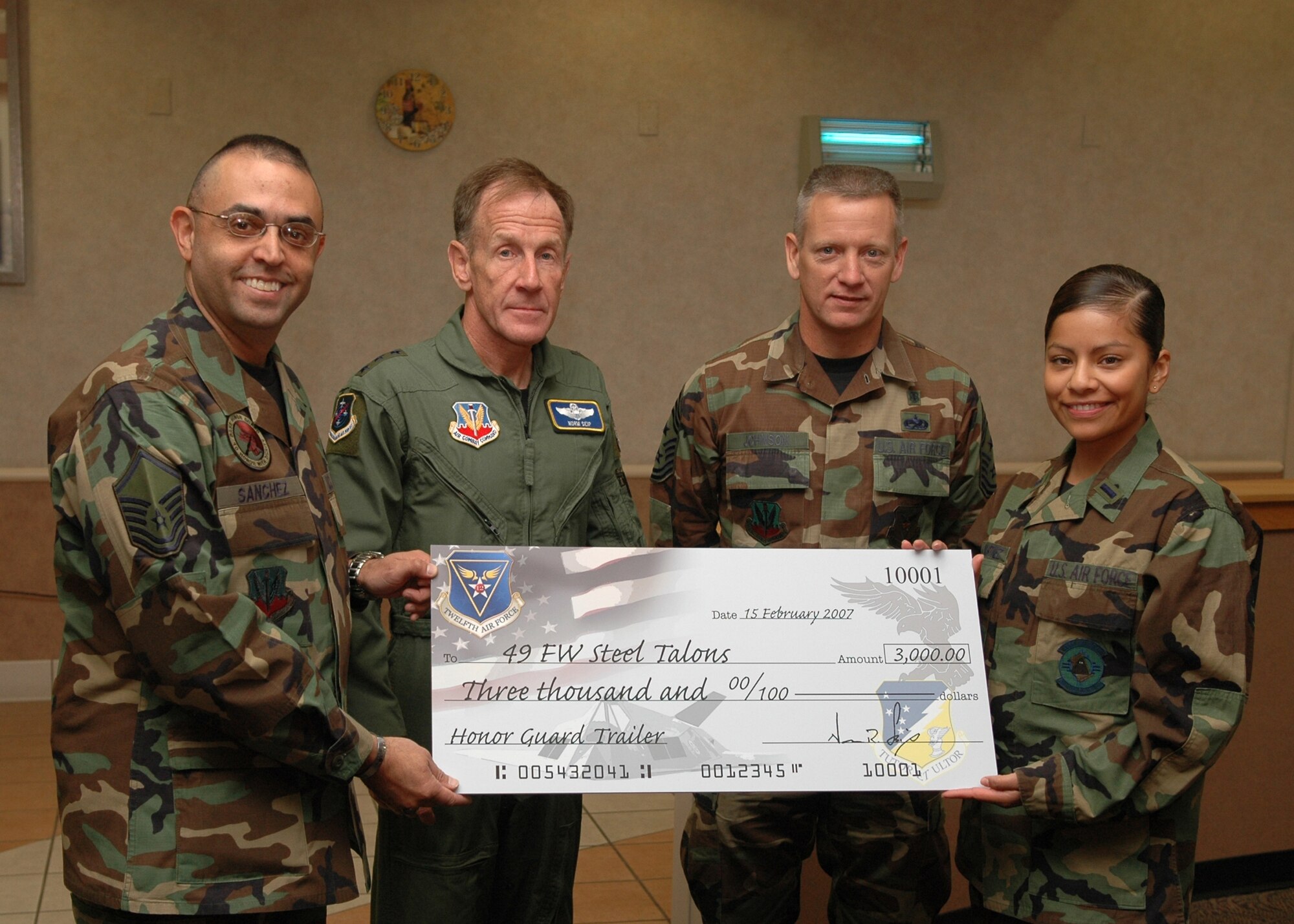 Lt. Gen. Norman Seip, 12th Air Force commander, presented the Holloman Steel Talons Honor Guard with a check for a trailer during the breakfast he had with the Steel Talons Feb. 15. (U.S. Air Force photo by Airman Jamal Sutter)