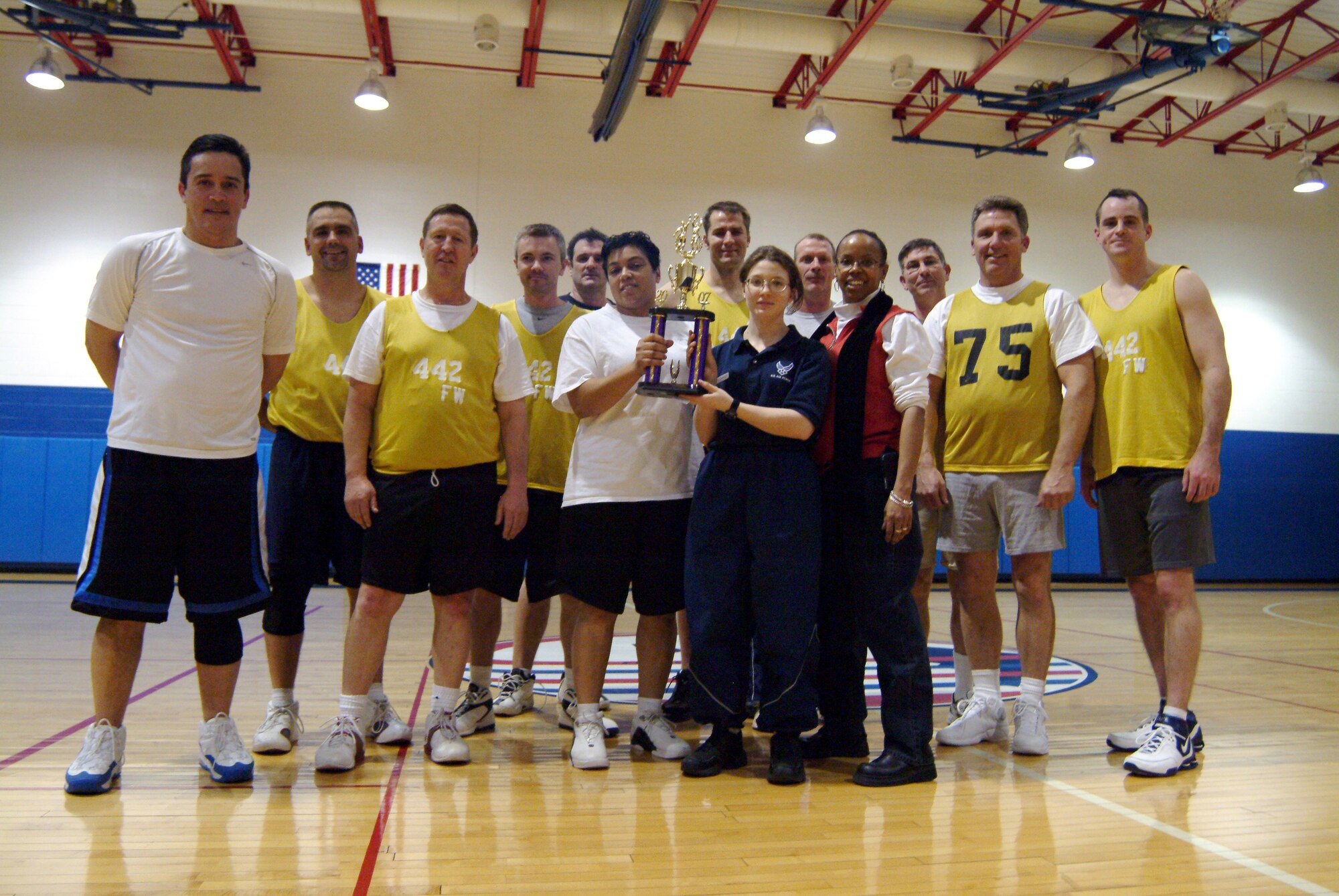 The 442nd Fighter Wing's Over-30, Intramural Basketball Team accept the 2007 championship trophy in the Whiteman Air Force Base gymnasium Feb. 15.  The team beat the 509th Security Forces Team 42-31 to win it's fourth championship in five years.  (U.S. Air Force photo/Maj. David Kurle)