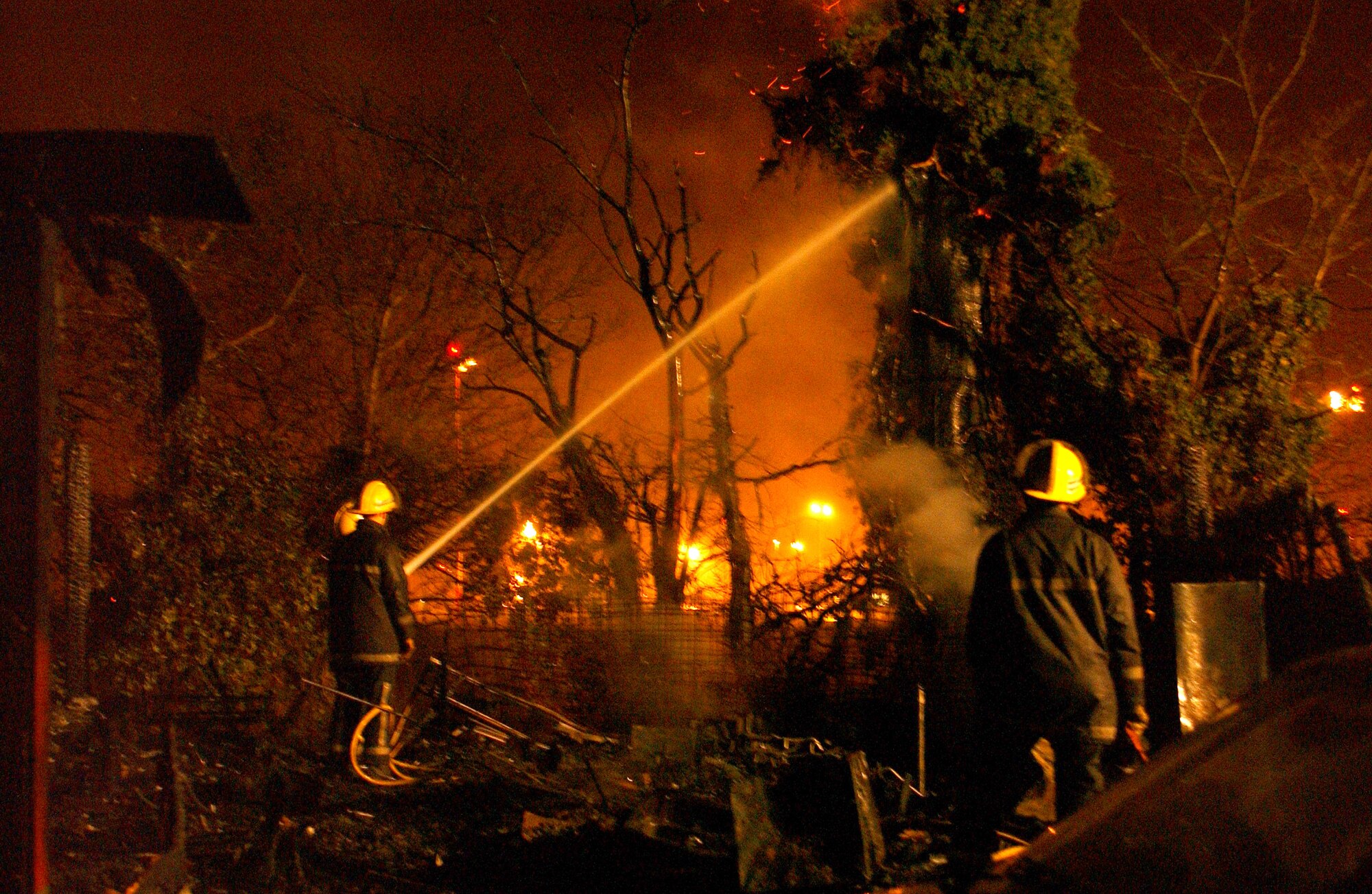 Air Force firefighters joined local British firefighters Feb. 21 to staunch a blaze soaring 50-feet high near RAF Mildenhall, England. Firefighters from 100th Civil Engineer Squadron at RAF Mildenhall joined firefighters from the Suffolk Fire Service at the off-base location. Together, they contained the fire preventing nearby structures and vehicles from being consumed. (U.S. Air Force photo/Staff Sgt. Valerie Smith)
