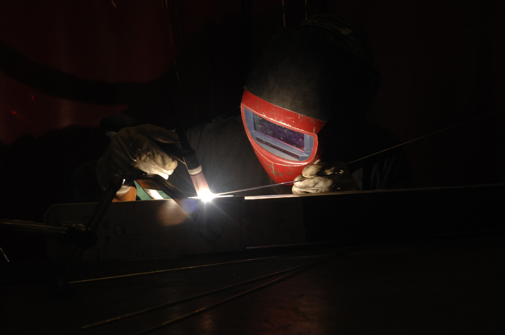 Senior Airman Daniel Tomlin, 48th Equipment Maintenance Squadron, welds on an aircraft tow bar used to taxi aircraft on the runway. Airman Tomlin is part of the metals technology shop, which is responsible for welding and machine maintenance for the F-15s. (Air Force photo by Airman 1st Class Jessica Snow)
