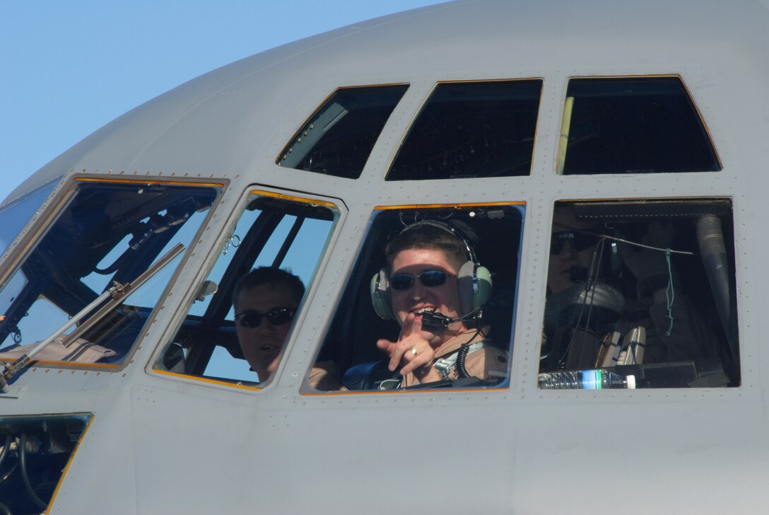 Maj. Jeffrey Wong points to a crowd waiting for him and other members of the 133rd Airlift Wing Feb. 17 at the Minneapolis St. Paul International Airport. Major Wong piloted the Minnesota Air National Guard C-130 Hercules that returned from deployment to Afghanistan supporting Operation Enduring Freedom. (U.S. Air Force photo/Tech. Sgt. Erik Gudmundson) 