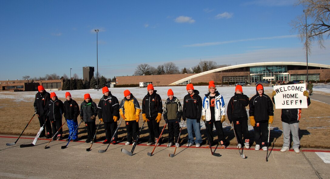 Members of the "Bears" hockey team braved the below zero wind chill to welcome home their coach, Maj. Jeffrey Wong, Feb. 17 at the Minneapolis St. Paul International Airport. Major Wong piloted the 133rd Airlift Wing Minnesota Air National Guard C-130 Hercules that just returned from deployment to Afghanistan supporting Operation Enduring Freedom. (U.S. Air Force photo/Tech. Sgt. Erik Gudmundson)