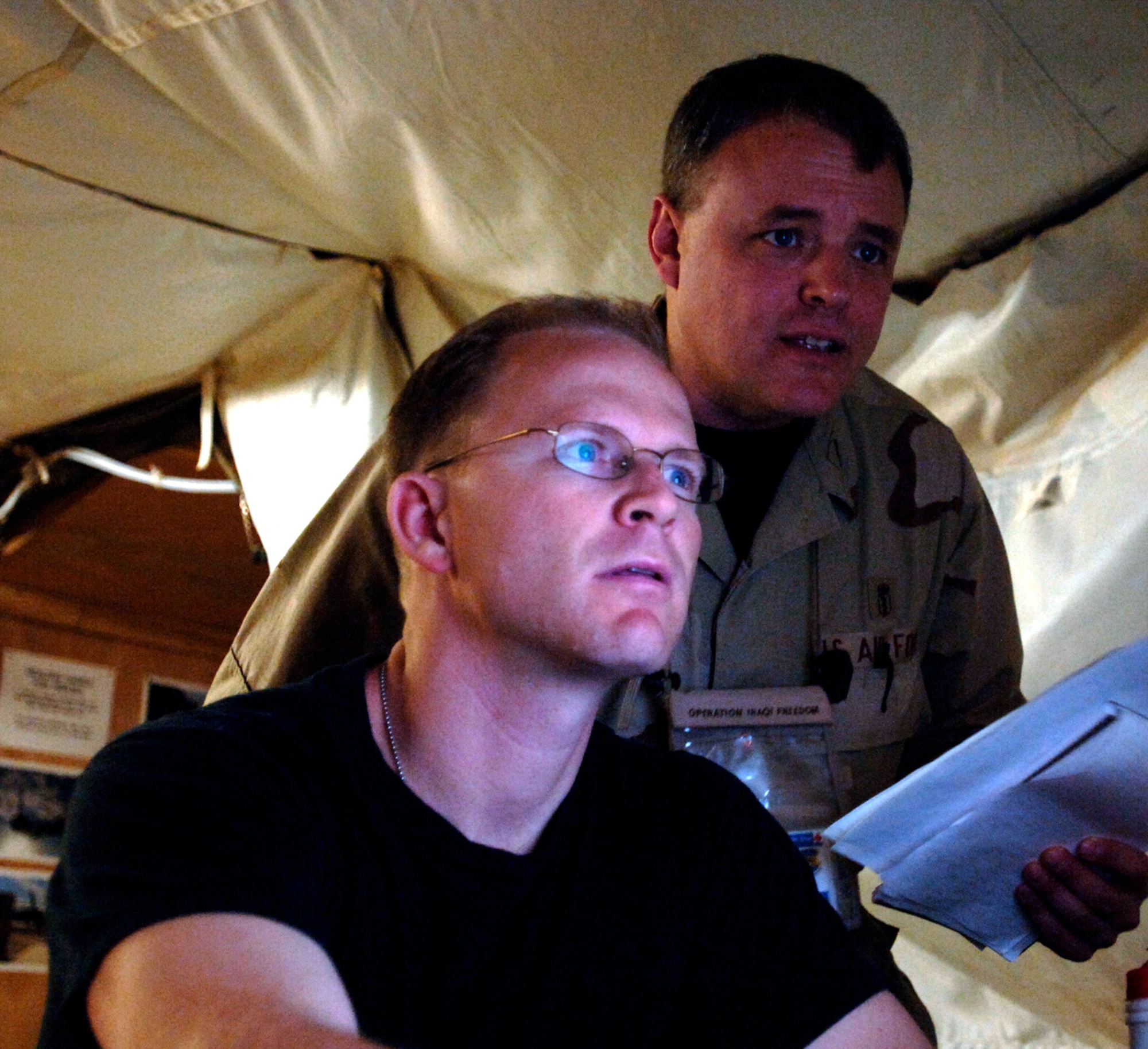 Maj. Dan Church (left) and Lt. Col. David Condie review CT scans and X-rays on current patients at the Air Force Theater Hospital Feb. 19 at Balad Air Base, Iraq. The radiology staff has two new 16 slice CT scanners that expedite the process from 90 minutes to about 10 minutes. Major Church and Colonel Condie are assigned to the 332nd Expeditionary Medical Group. (U.S. Air Force photo/Tech. Sgt. Cecilio M. Ricardo Jr.)