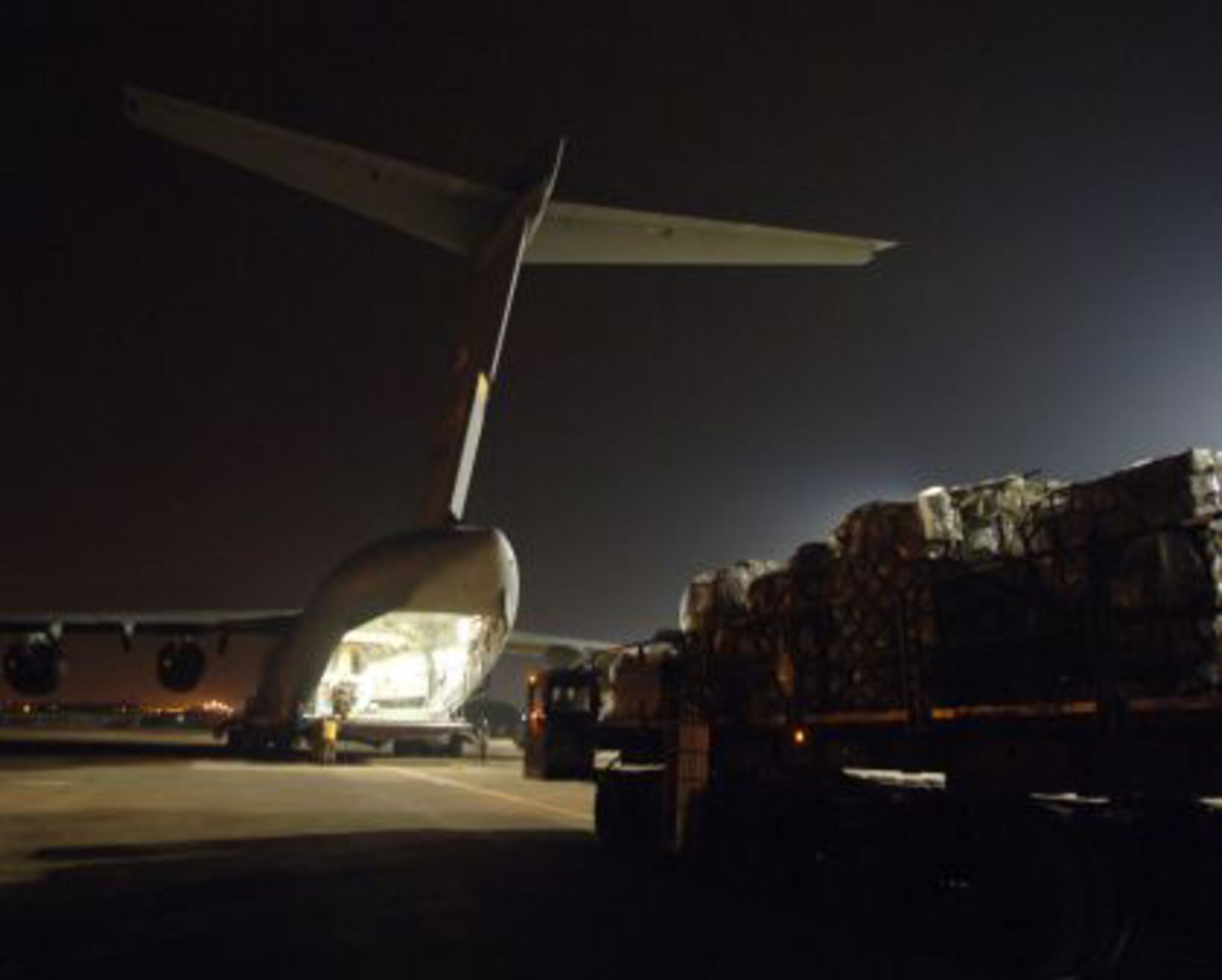 INCIRLIK AIR BASE, Turkey -- A portion of 94,000 pounds of cargo is loaded onto a C-17 Feb. 21 before reaching its final destination of Kabul Air Base, Afghanistan.  A total of 23 pallets and five trailers were palletized by Turkish and U.S. Air Force servicemembers in a joint effort that was accomplished on two C-17 flights.  The pallets and trailers loaded for transport included uniforms and equipment for the Afghan army. (U.S. Air Force photo by Airman 1st Class Nathan Lipscomb)