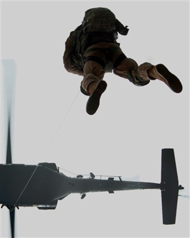 U.S. Army Sgt. Robert Cowdrey dangles at the end of a long wire as he is hoisted into an UH-60 Black Hawk helicopter during a training exercise at Forward Operating Base Salerno, Afghanistan, on Feb. 11, 2007.  The purpose of the exercise is to practice casualty rescue procedures for difficult landing terrains.  Cowdrey is a flight medic from Charlie Company, 3rd Battalion, 82nd Aviation Brigade, 82nd Airborne Division.  