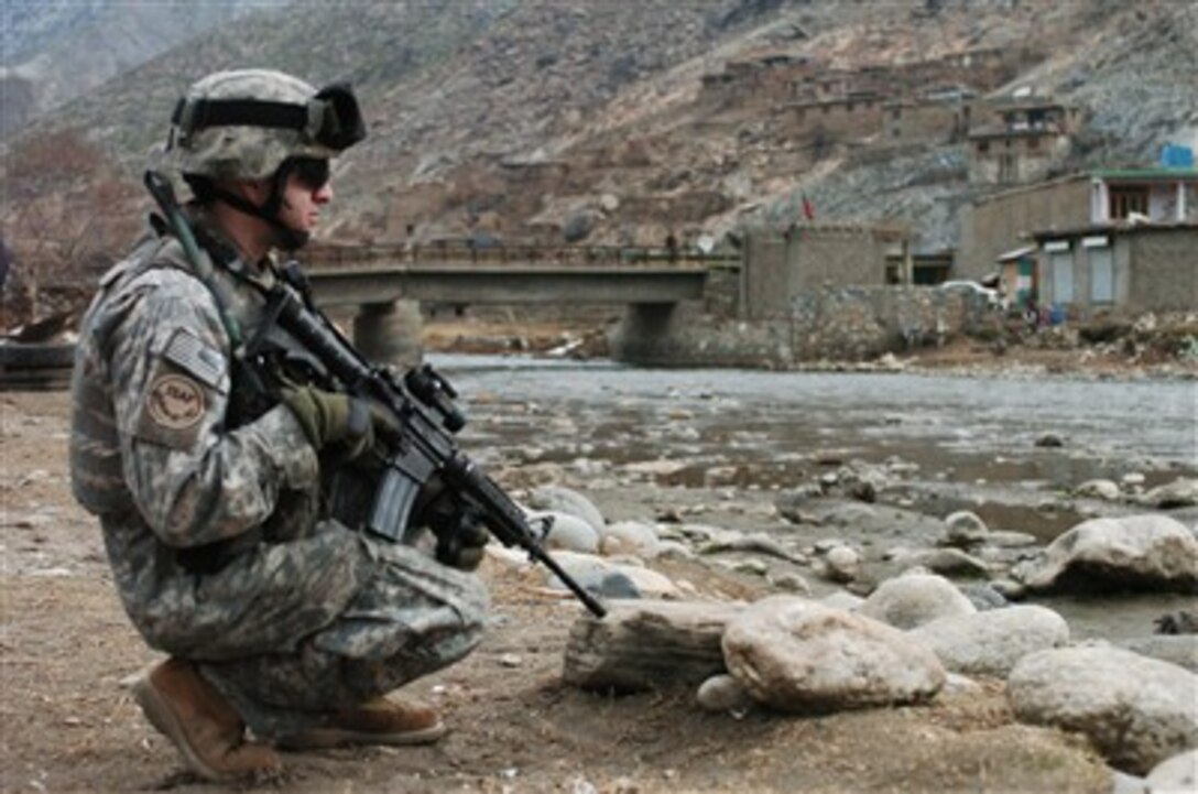 U.S. Army Staff Sgt. Michael Kaman helps secure an area along the Pech River during a meeting between key leaders in the Kunar province of Afghanistan on Feb. 4, 2007.  The purpose of the meeting was to discuss local development projects that are a combined effort of the Coalition led Asadabad Provincial Reconstruction Team and local contractors. Kaman is attached to the 1st Battalion, 102nd Infantry Regiment, Connecticut National Guard.  