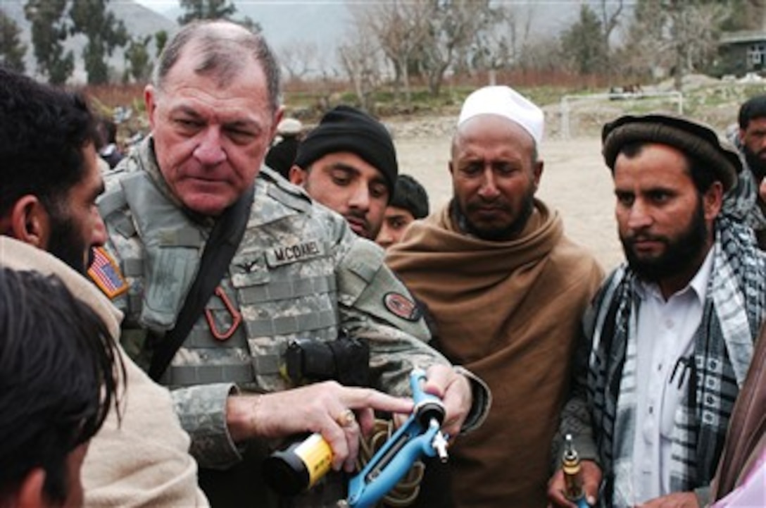 U.S. Army Col. Sidney McDaniel shows Afghan veterinarians how to use new medicines during a conference in Asadabad, Afghanistan, on Feb. 5, 2007.  U.S. military veterinarians are training their Afghan counterparts on how to use new medicines that have been donated by drug companies.  