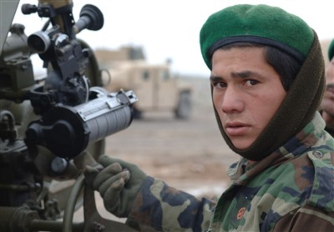 An Afghan National Army field artillery soldier turns the elevation wheel on a D-30 122mm Howitzer while rehearsing crew drills in Shirzai, Afghanistan, Feb. 11, 2007. 