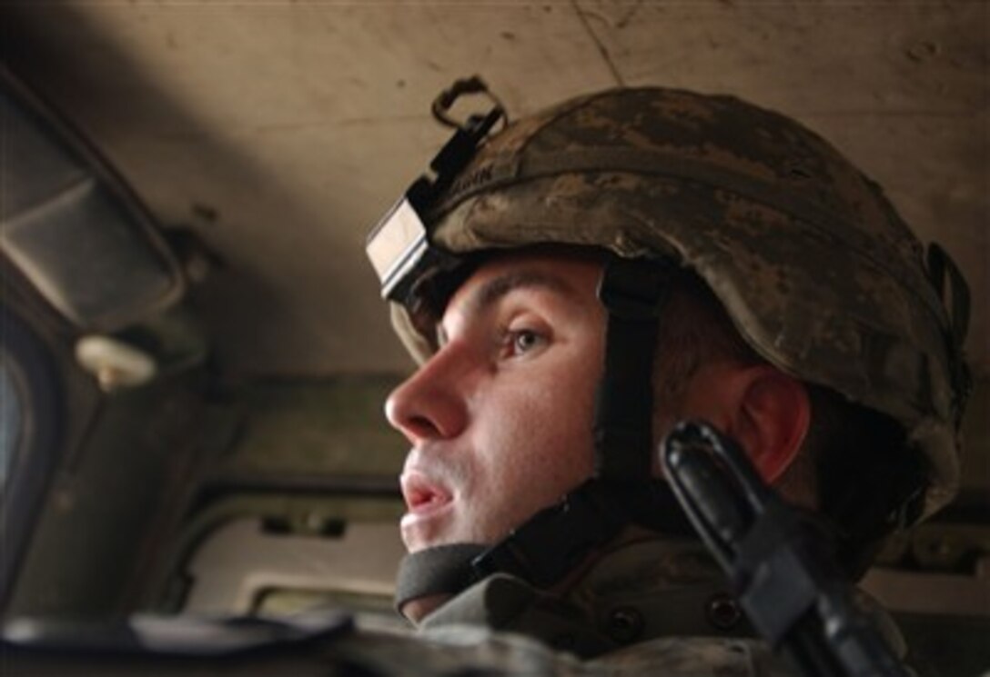 U.S. Army Staff Sgt. Michael Cragin, from 2nd Battalion, 7th Cavalry Regiment, 4th Brigade Combat Team, 1st Cavalry Division, instructs his driver during a recon mission across Mosul, Iraq, Feb. 10, 2007.