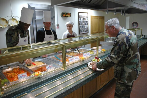 (Left to right) Master Sgts. Terrell Murray and Craig Colby, both 388th Aircraft Maintenance Squadron assistant first sergeants, serve lunch Wednesday, along with Hannelore Crawford, Hillcrest Dining Facility employee, to Tech. Sgt. Norman Kososki, 419th Fighter Wing. Hill Air Force Base first sergeants serve Airmen lunch at the dining facility on the third Wednesday of each month.