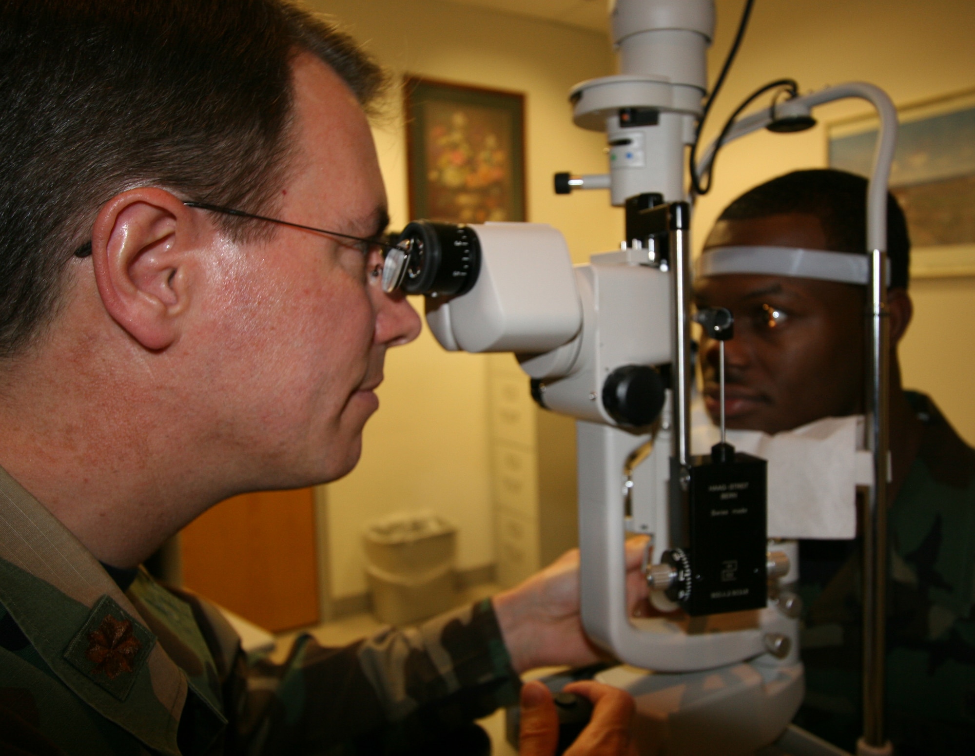 Maj. (Dr.) Marvin Acquistapace, Optometry Flight commander uses a photo bio-microscope for a evaluation that would be done pre and post operation after laser eye surgery. 