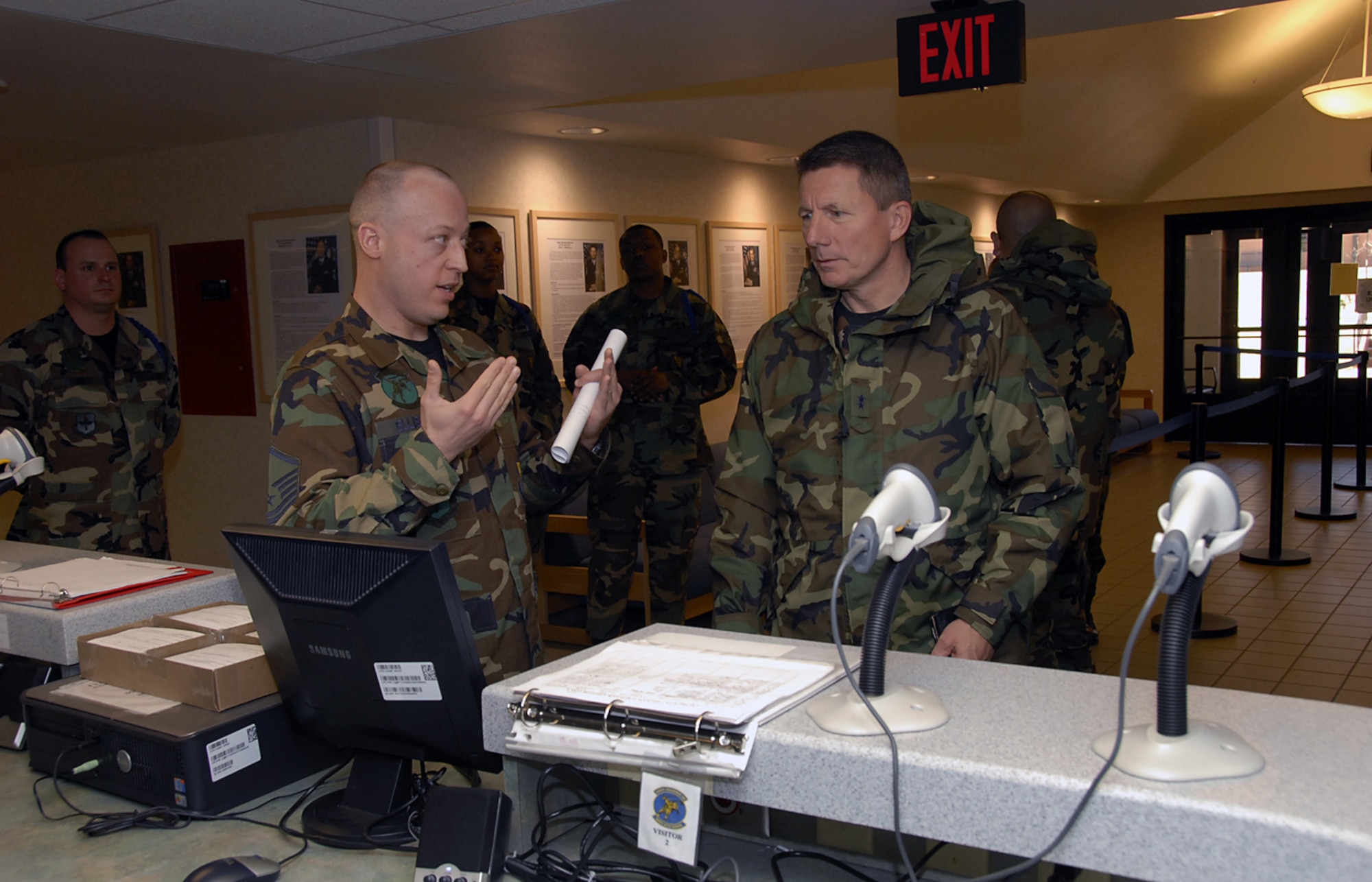 Master Sgt. Bradley Ellison, flight chief for the 364th Training Squadron, explains the ID card scanner system available in Sheppard AFB's newest dormitories to Maj. Gen. Michael Gould, 2nd Air Force commander.  General Gould visited Sheppard from Keesler AFB, Miss., as a guest speaker for the 82nd TRW annual awards banquet that evening. (U.S. Air Force Photo/Sandy Wassenmiller)