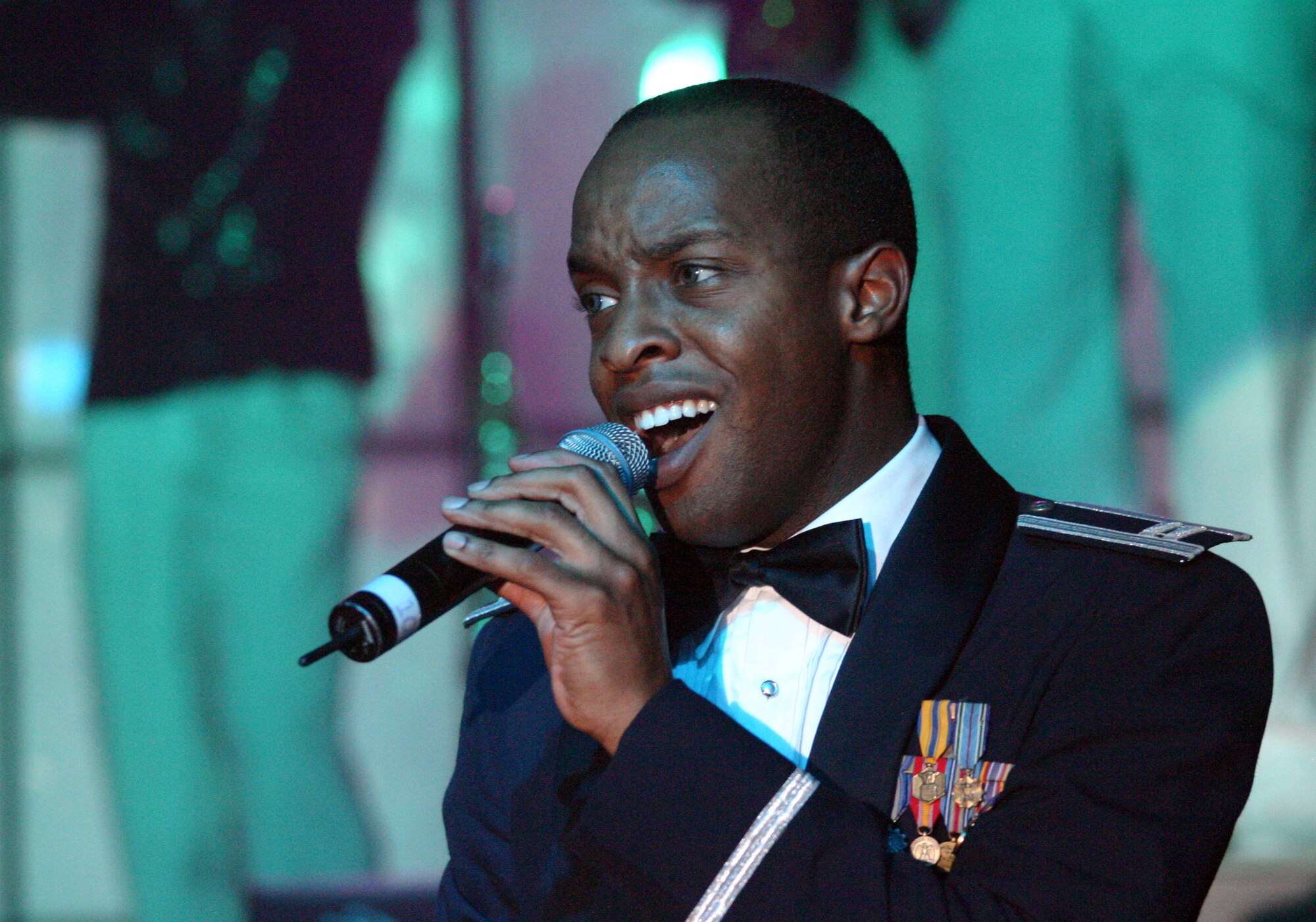 LAUGHLIN AIR FORCE BASE, TEXAS -- Tops in Blue vocalist and operations officer Capt. Sean Carter sings during the concert’s finale.  (U.S. Air Force photo by Airman Sara Csurilla)