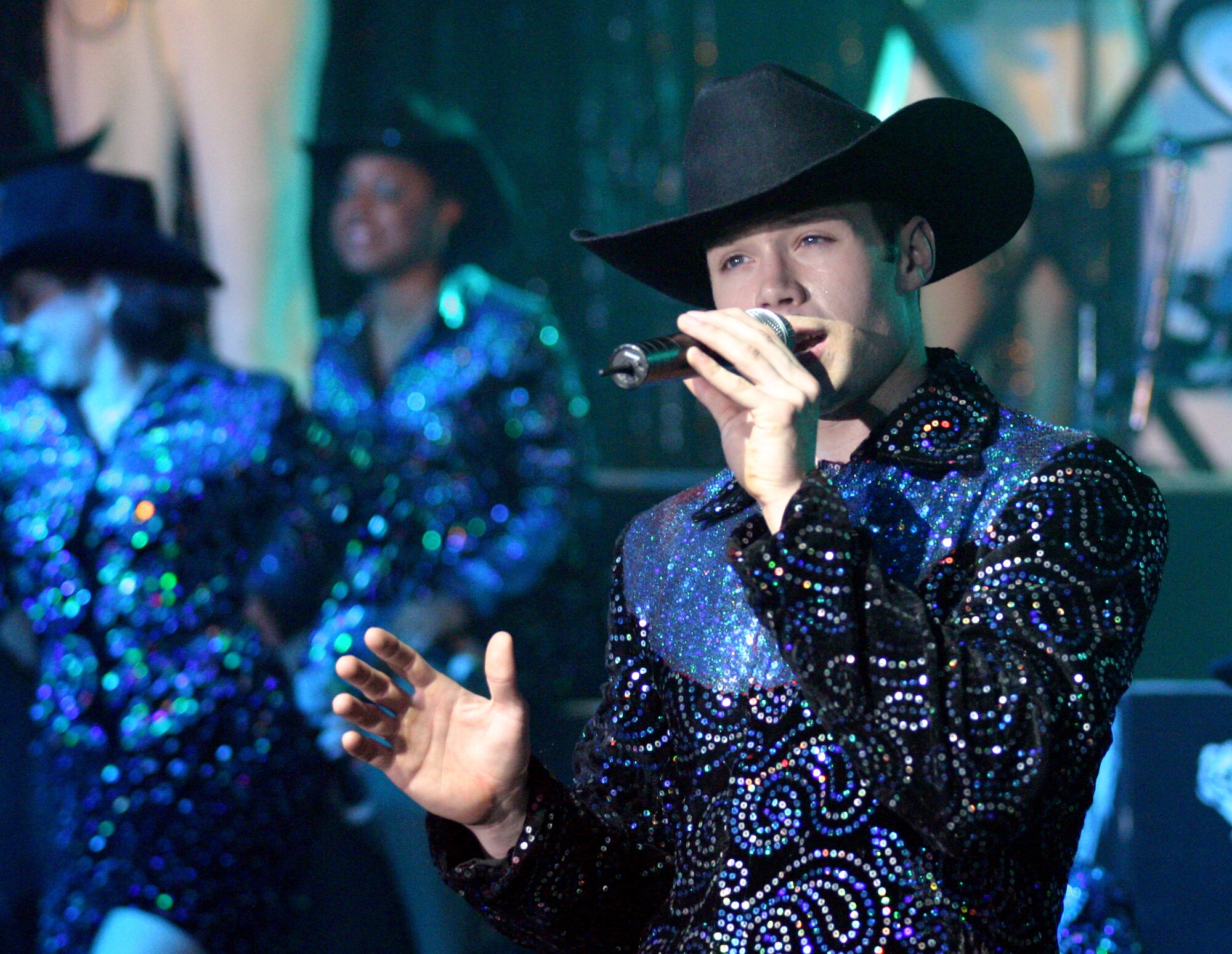 Tops in Blue vocalist Senior Airman Daniel Griner belts out classic country love songs during a performance Feb. 20.  (U.S. Air Force photo by Airman Sara Csurilla)