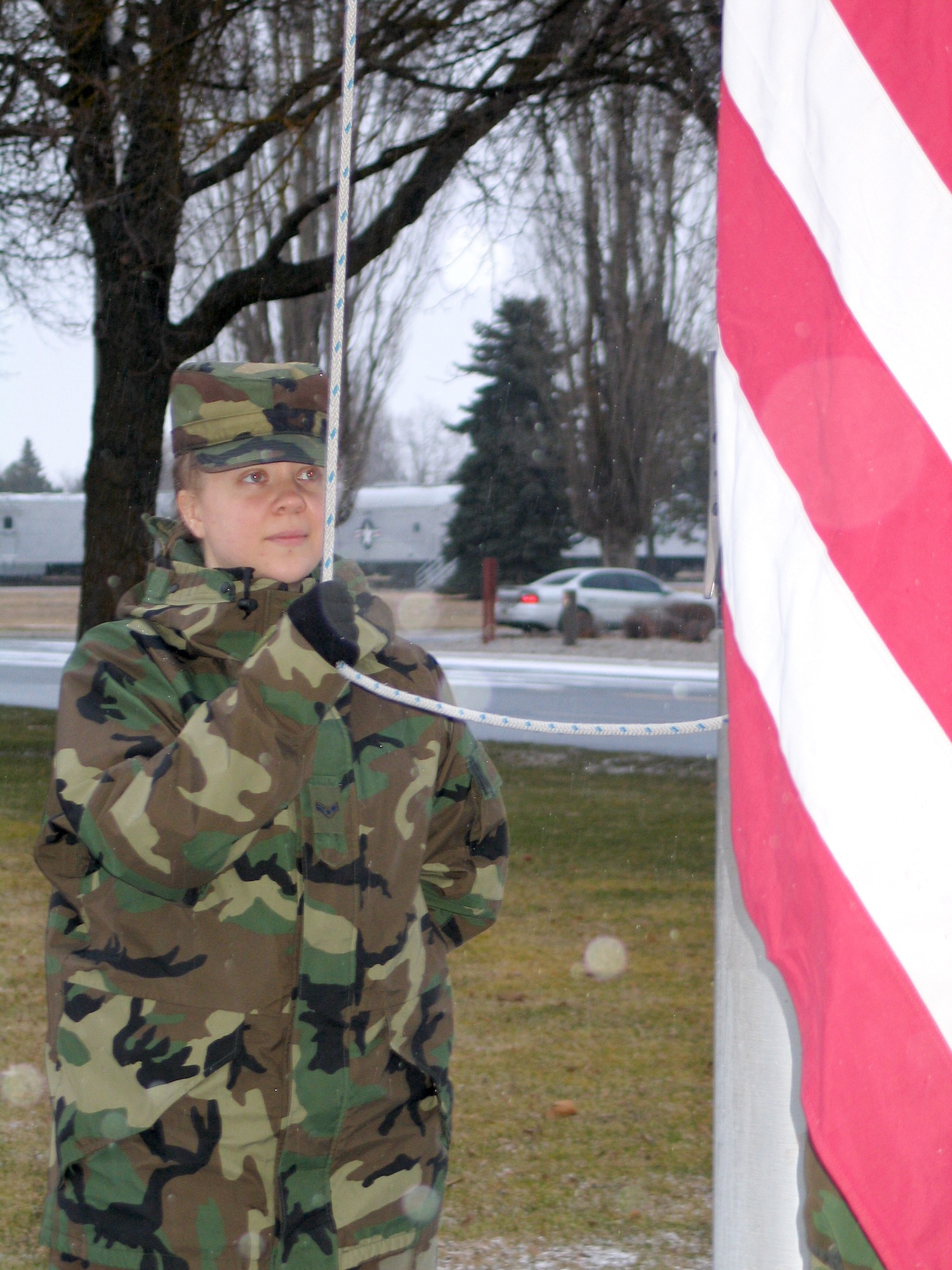 FAIRCHILD AIR FORCE BASE, Wash. -- Airman 1st Class Jocelyn Ford, 92nd Air Refueling Squadron Communications Squadron, waits for reveille to post the American flag. (Photo by Staff Sgt. Connie L. Bias)